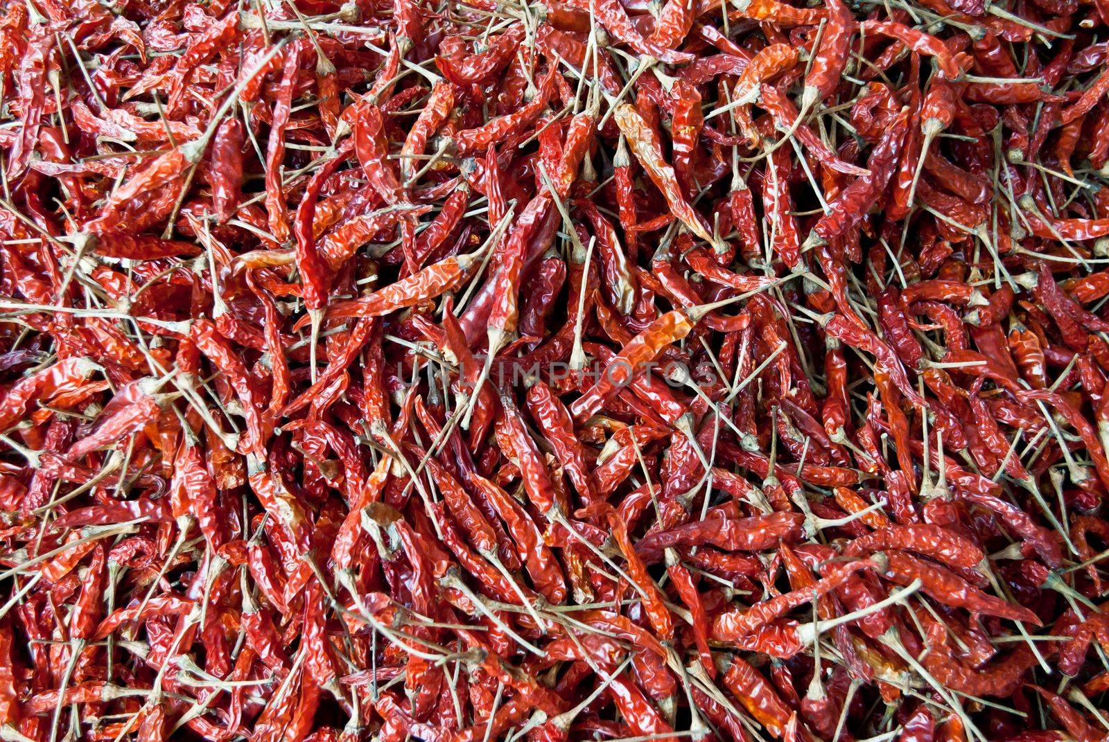 image of  dried red chillies as a textured food background. by rakoptonLPN