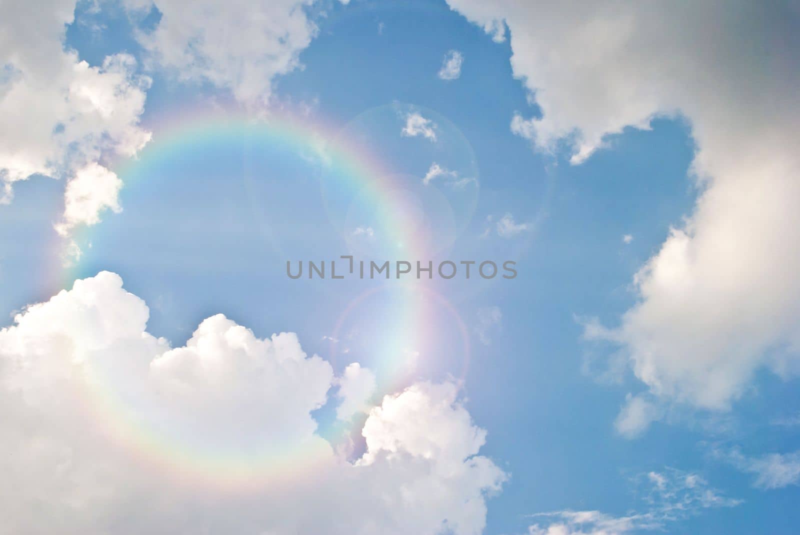 image of blue sky and white clouds with lighting flare