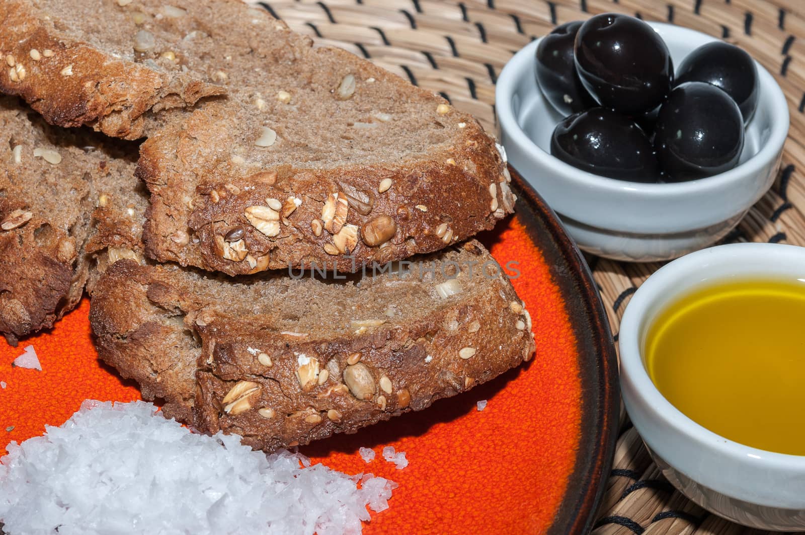 Slices of rye bread with oil, salt and black olives