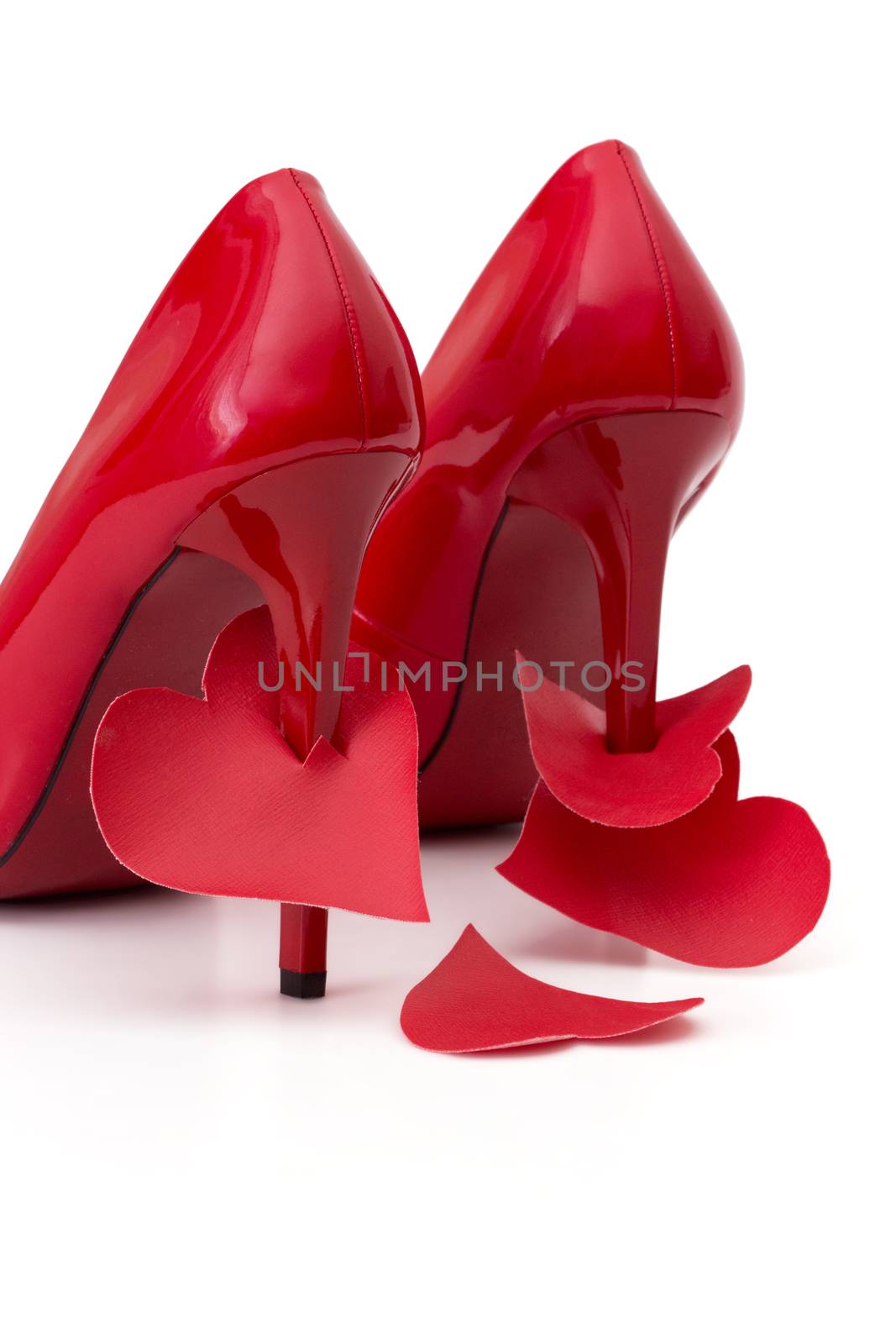 Heart strung on  high heels female shoes on a white background
