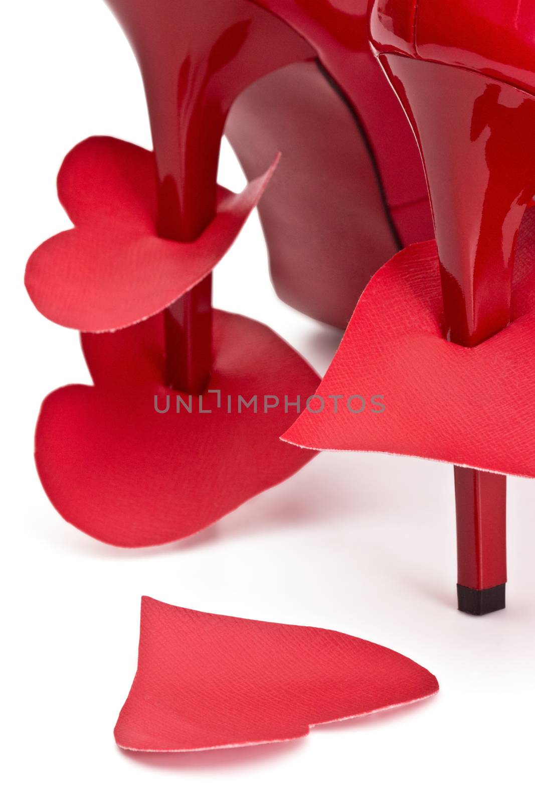 Heart strung on  high heels female shoes on a white background