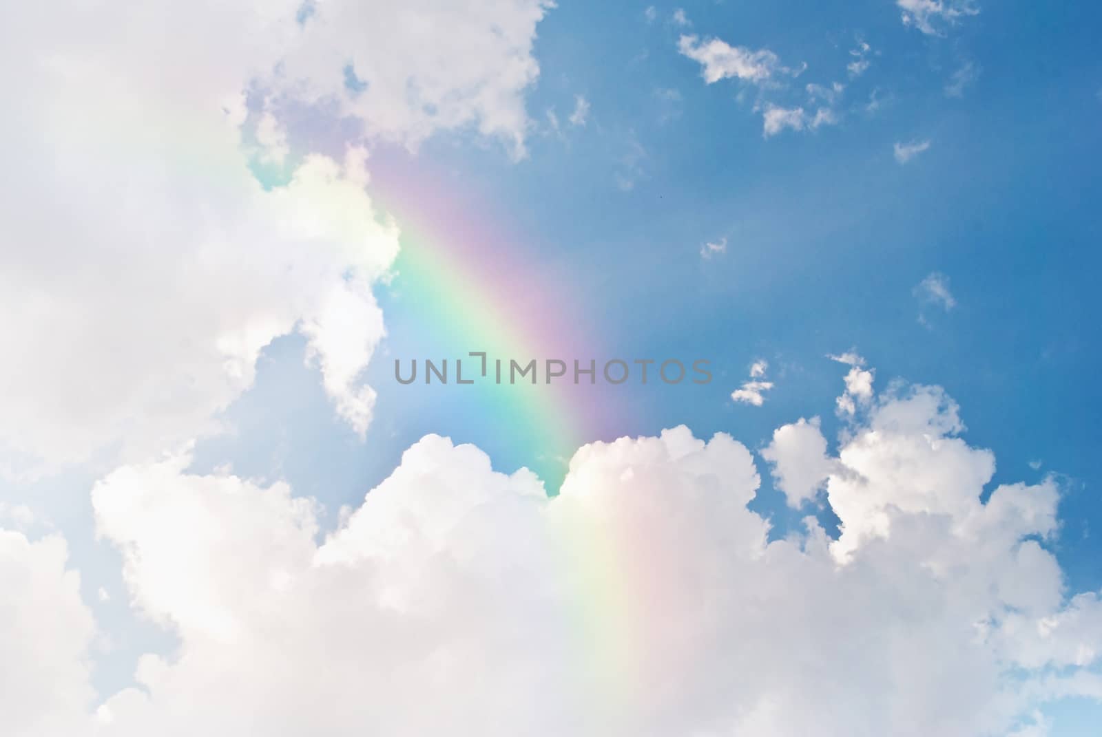 image of blue sky and white clouds with rainbow by rakoptonLPN