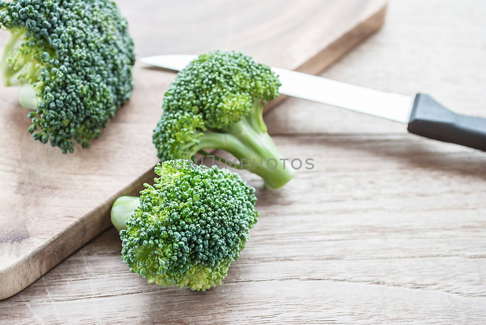 Fresh broccoli vegetable on wooden table by rakoptonLPN