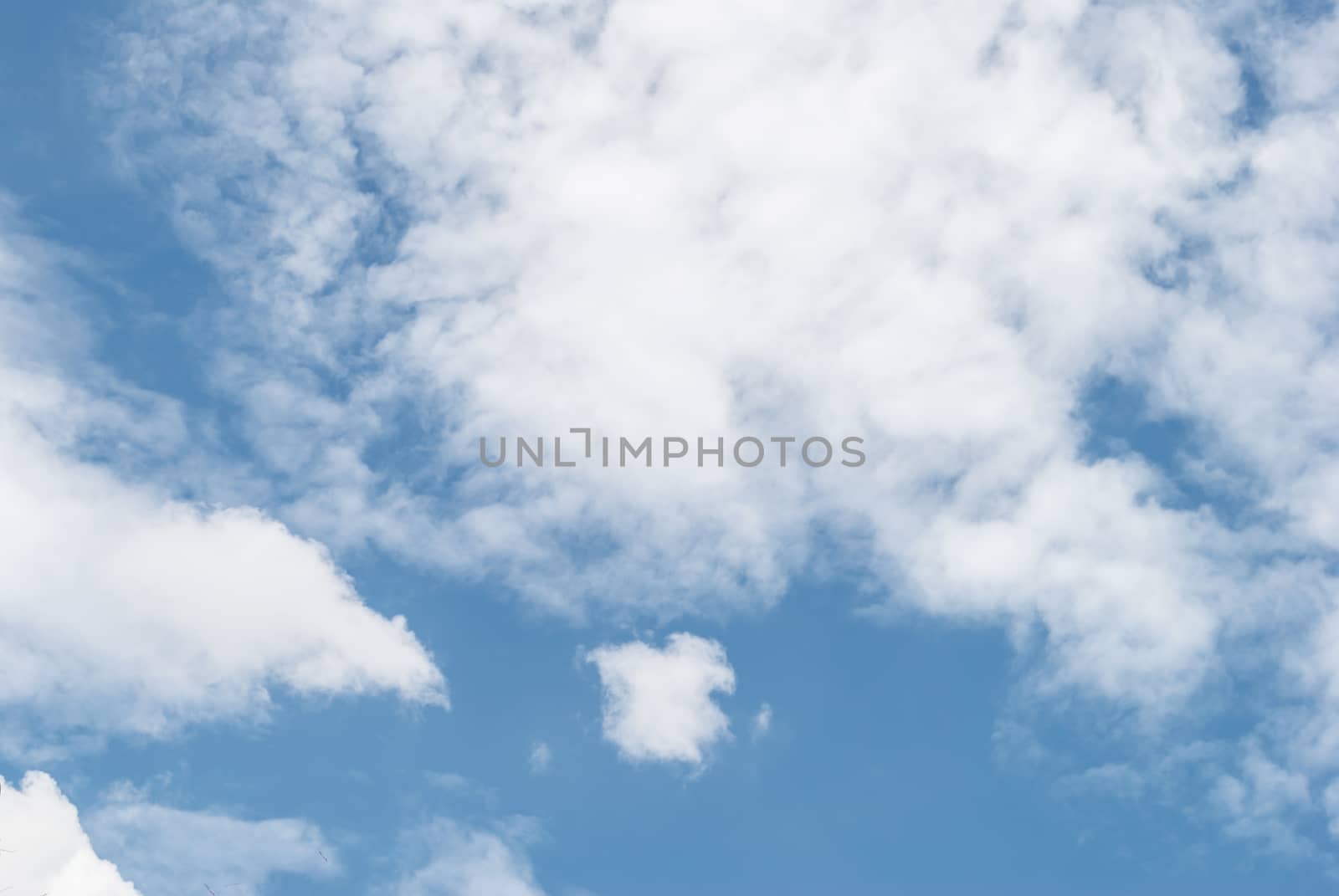 white fluffy clouds in the blue sky, for background by rakoptonLPN