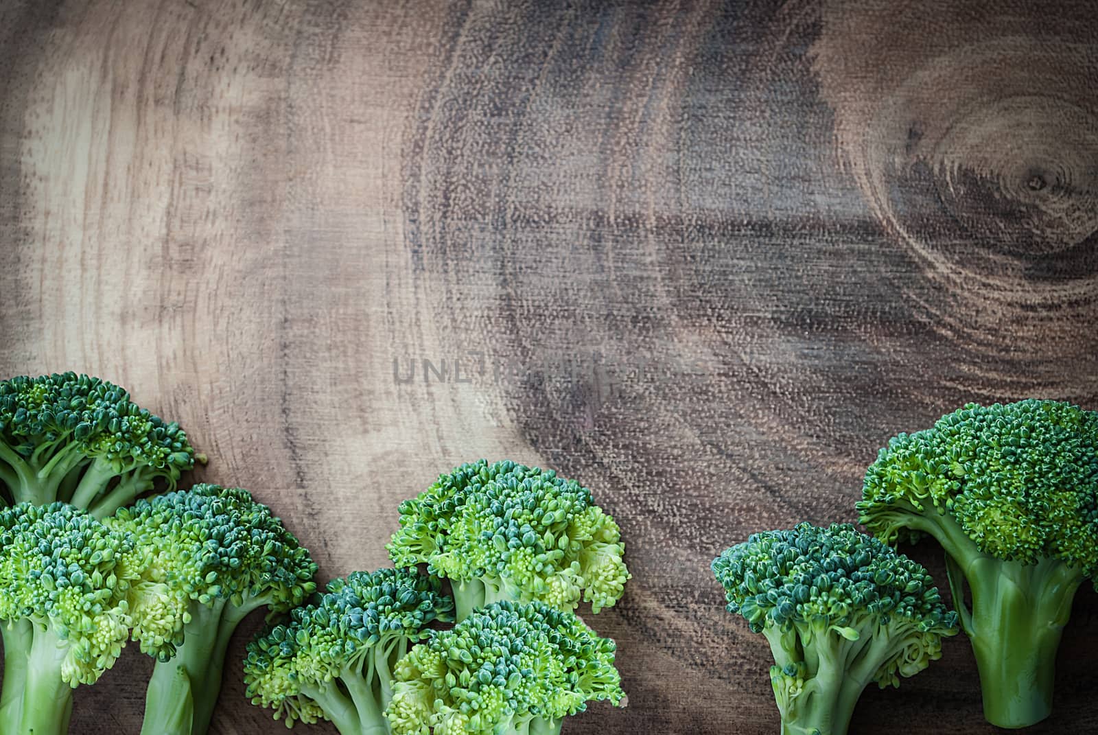 Fresh broccoli on wooden board for background