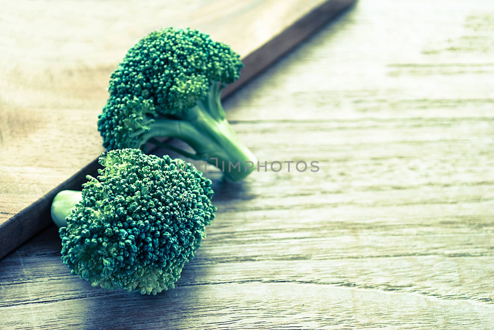 Fresh broccoli on wooden board for background, vintage style