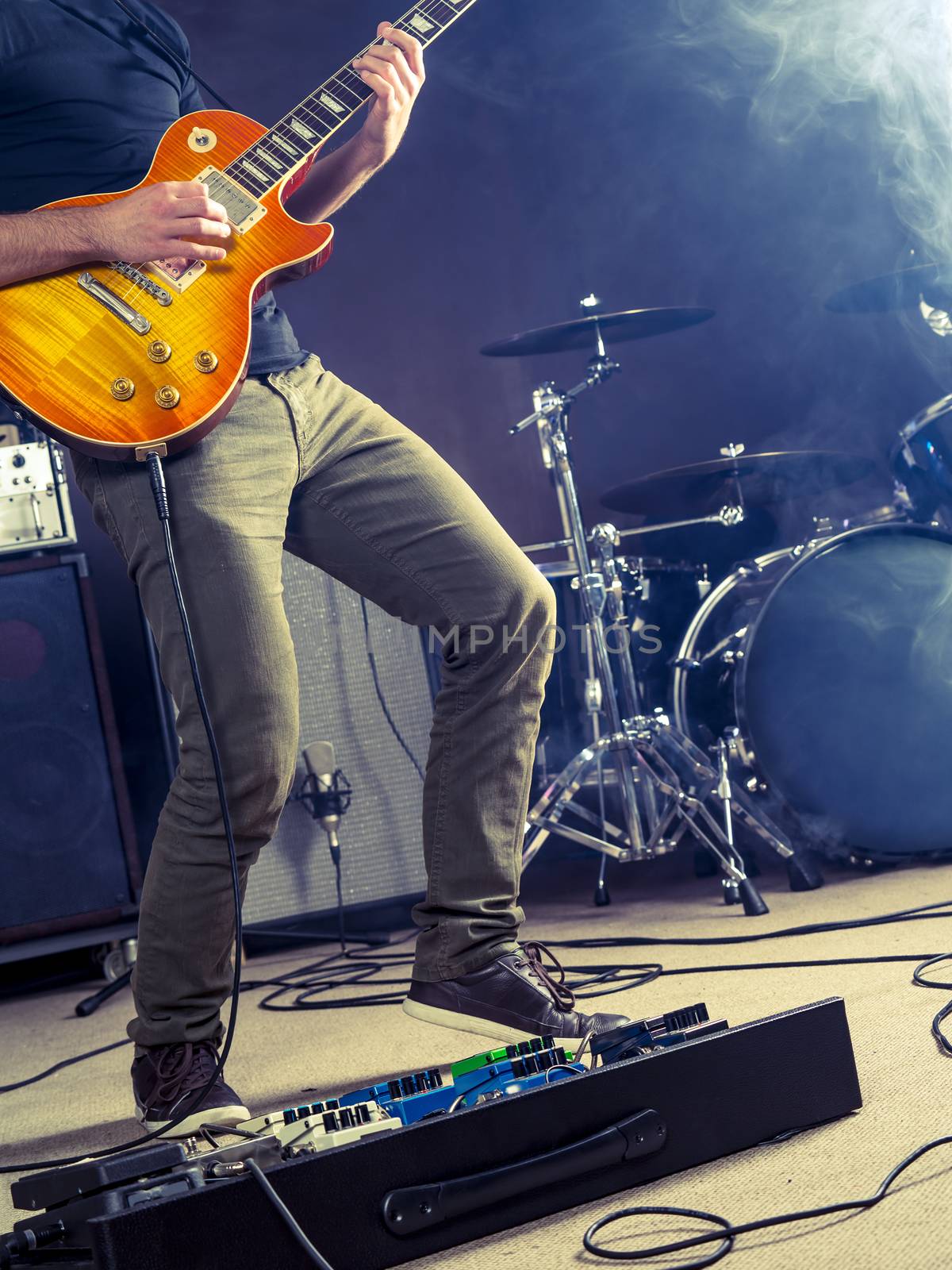 Photo of a guitar player playing on stage.