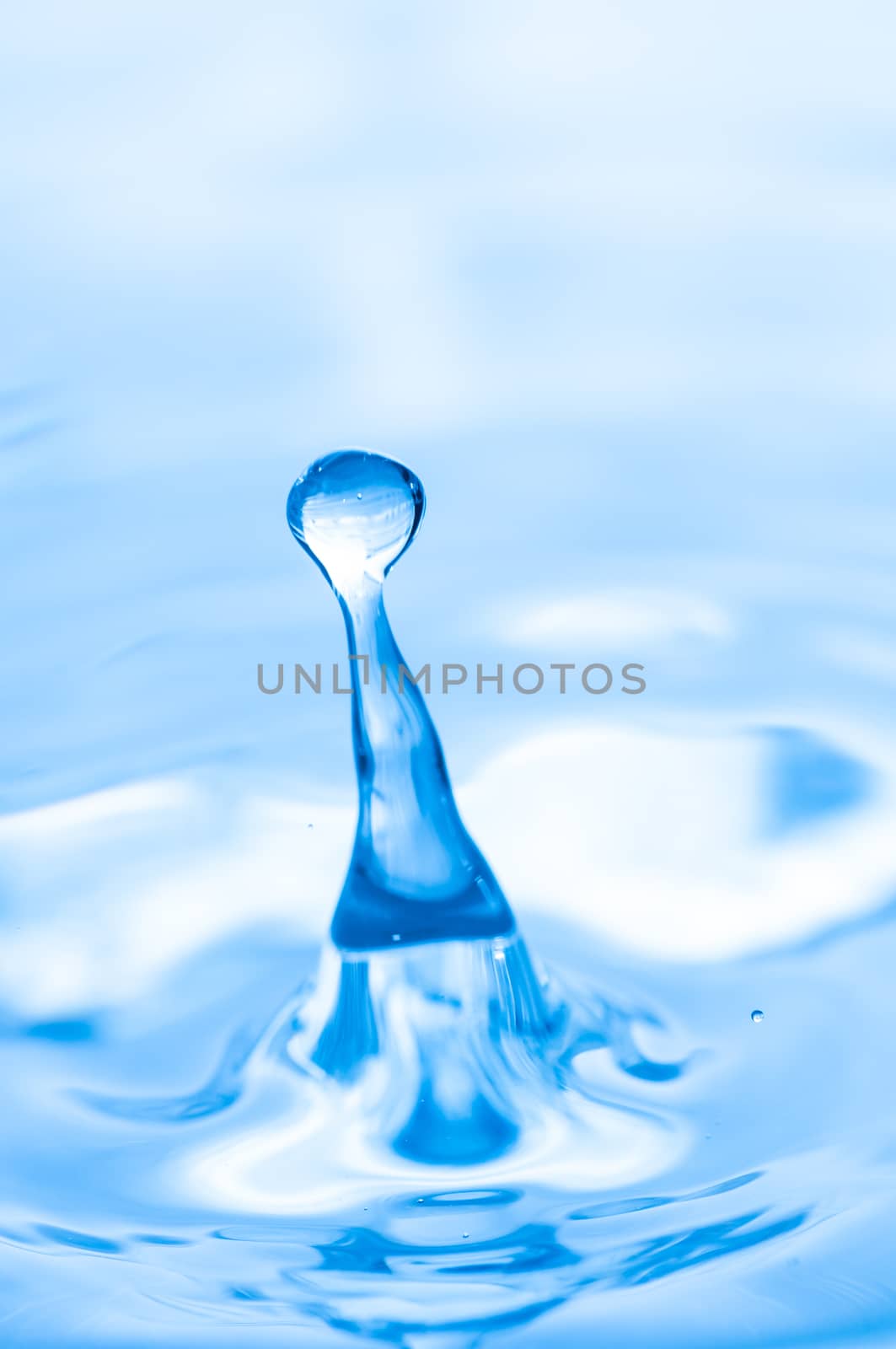 Blue water droplet captured with high speed lights