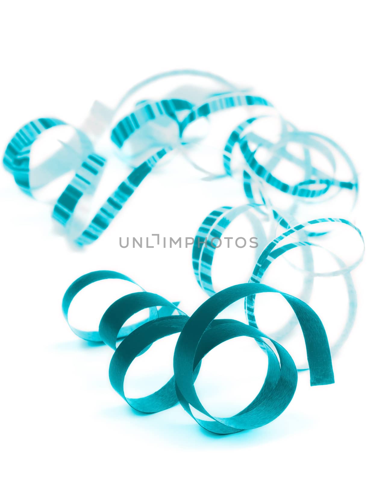 Arrangement of Blue and Striped Curled Party Streamers Lying on white background. Focus on Foreground