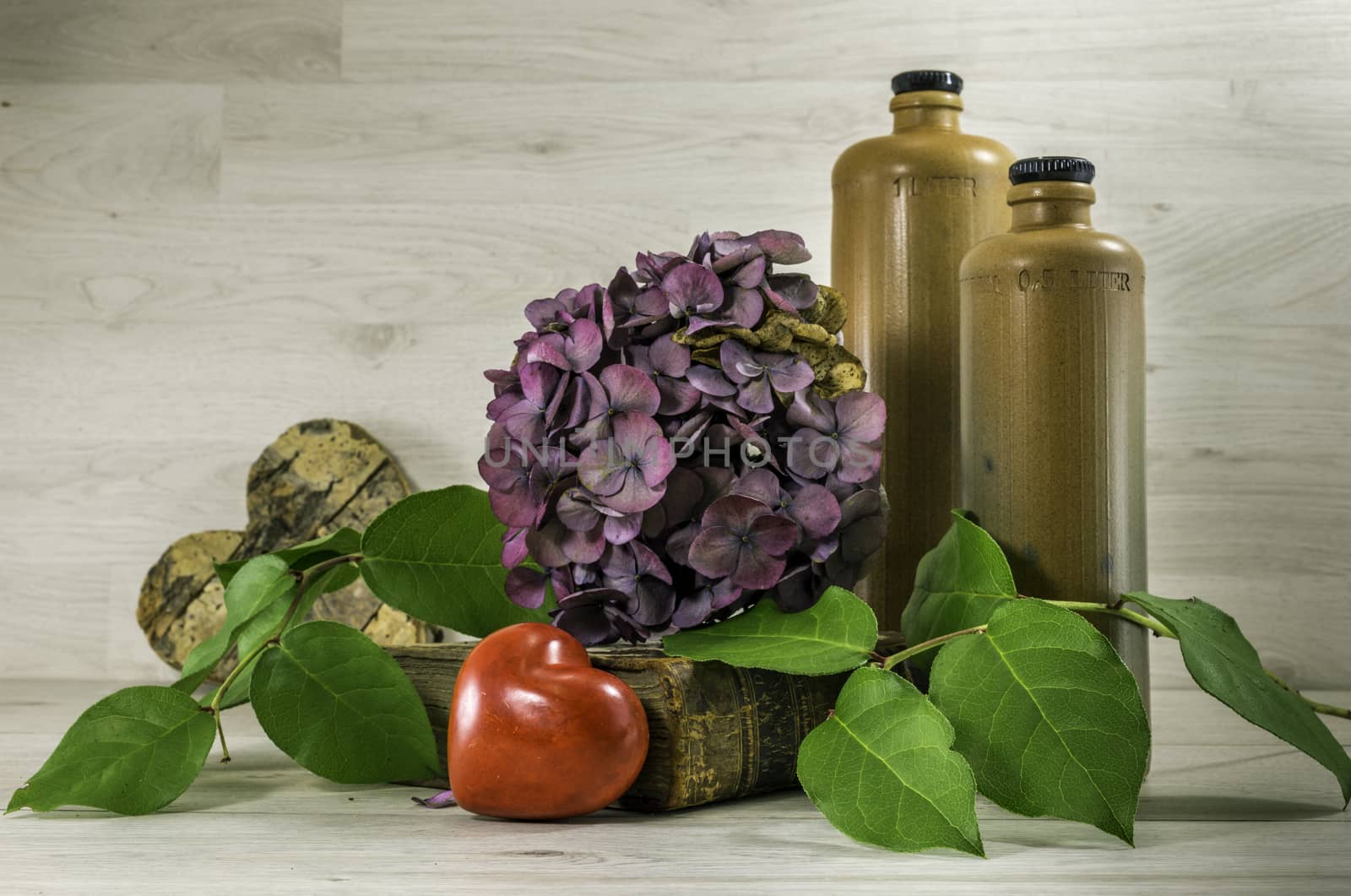 stil life  with stone bottles on wooden background