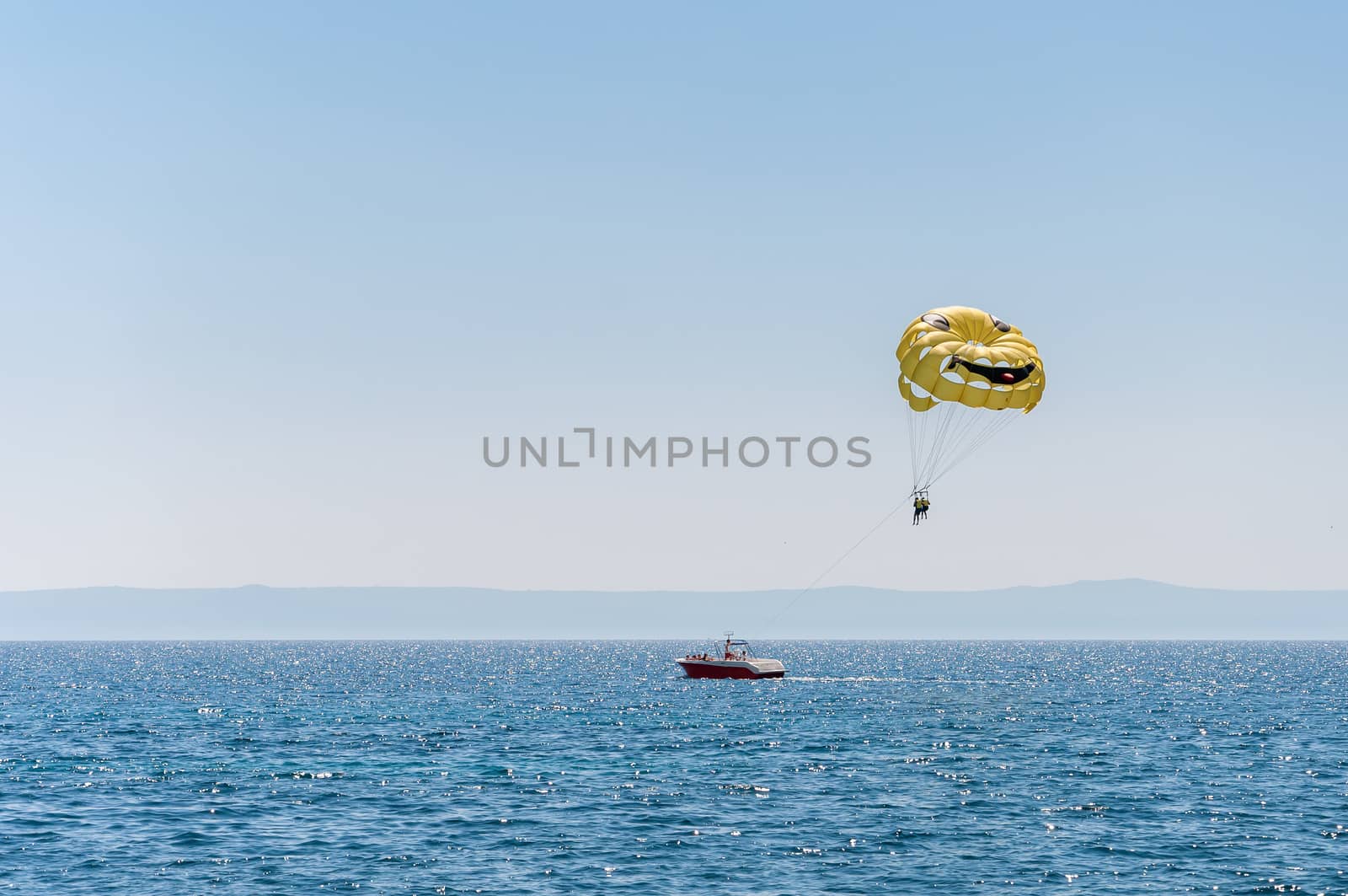 Parasailing over the Adriatic Sea on a sunny day