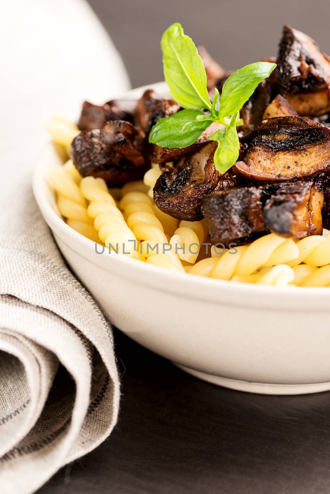 Fusilli with mushrooms, italian cuisine