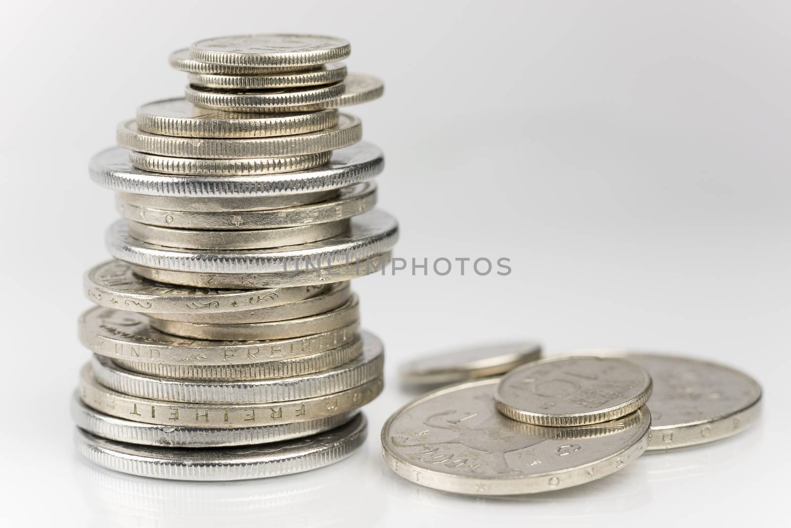 Stacked old European coins before the introduction of the Euro
