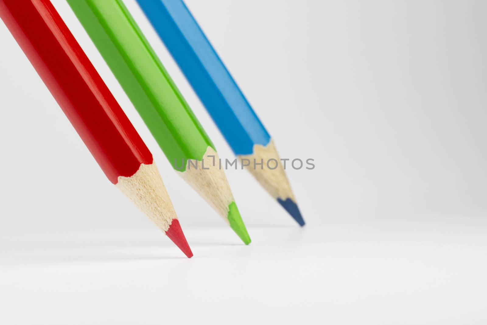 Three standing colored pencils in RGB colors
