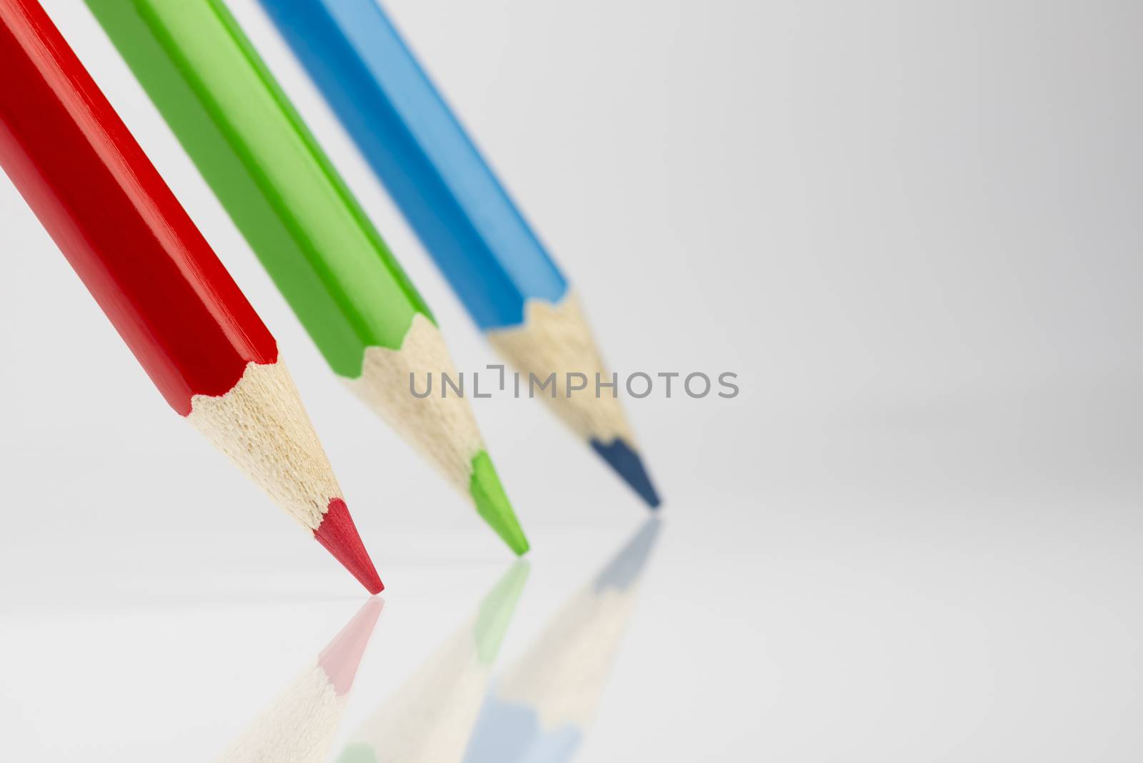 Three standing colored pencils in RGB colors
