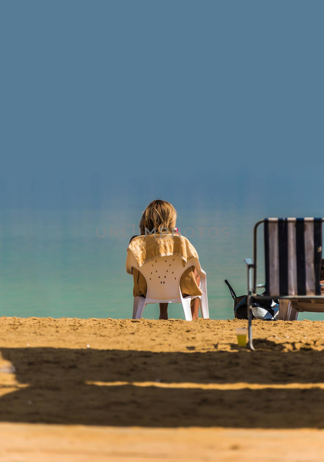 Woman relaxing on the beach Dead Sea by MegaArt