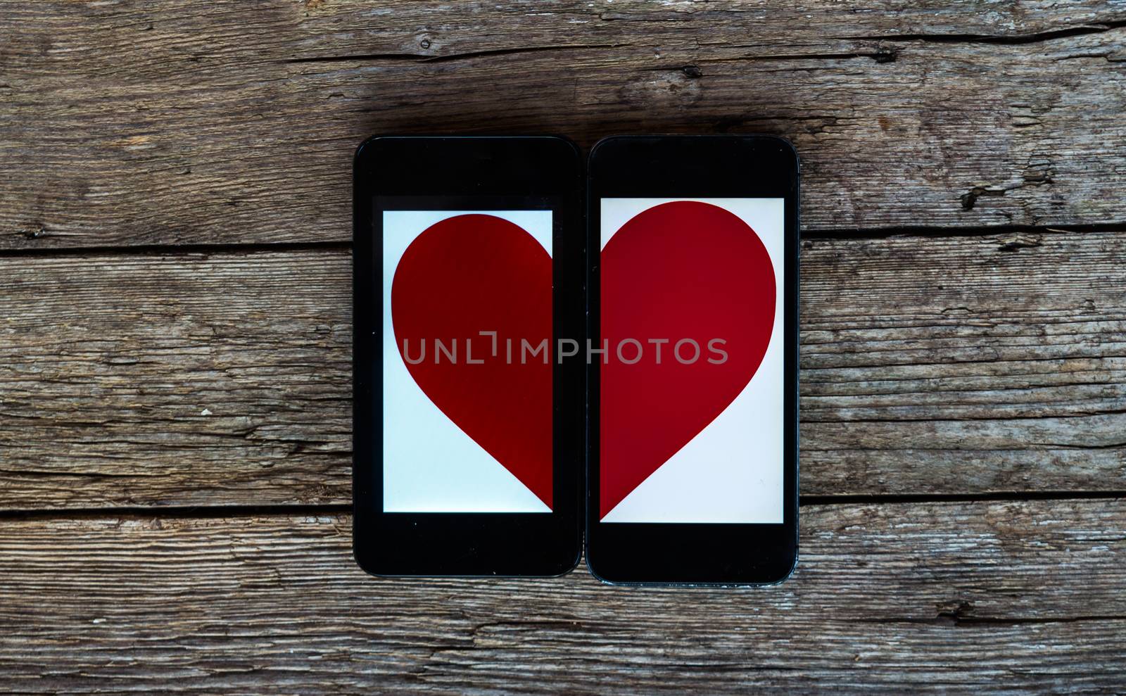 Two Cellphones With Half Heart Symbol by radzonimo