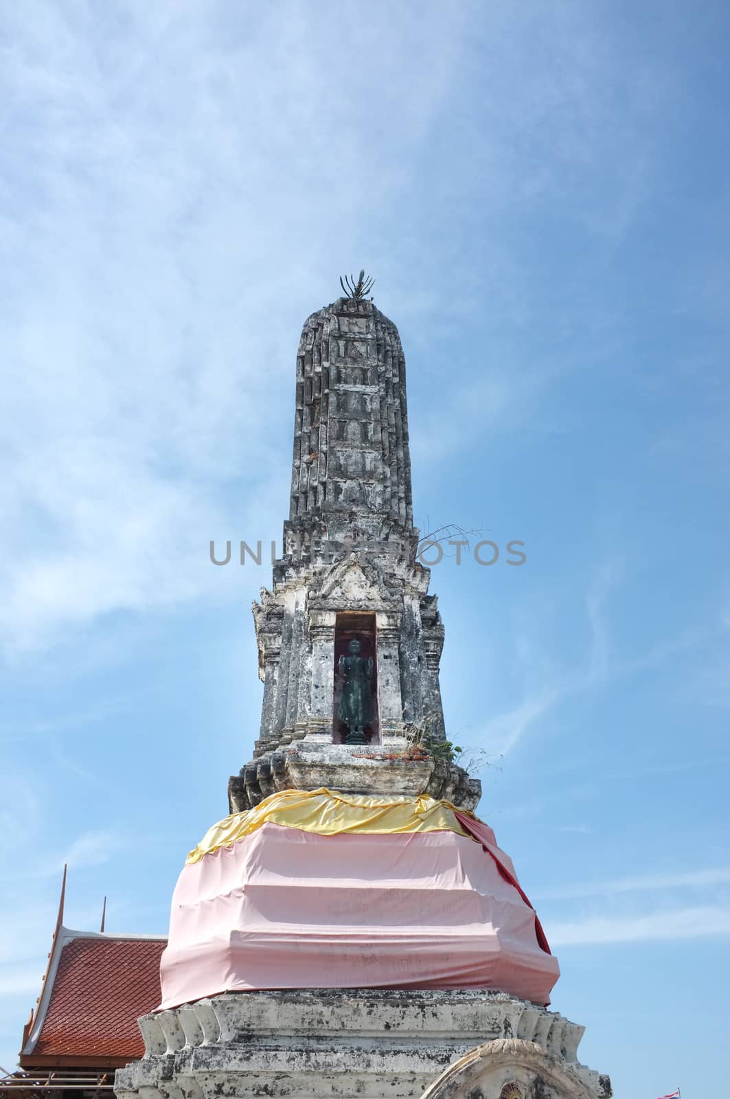 Ancient stupa in temple of Thailand with blue sky background