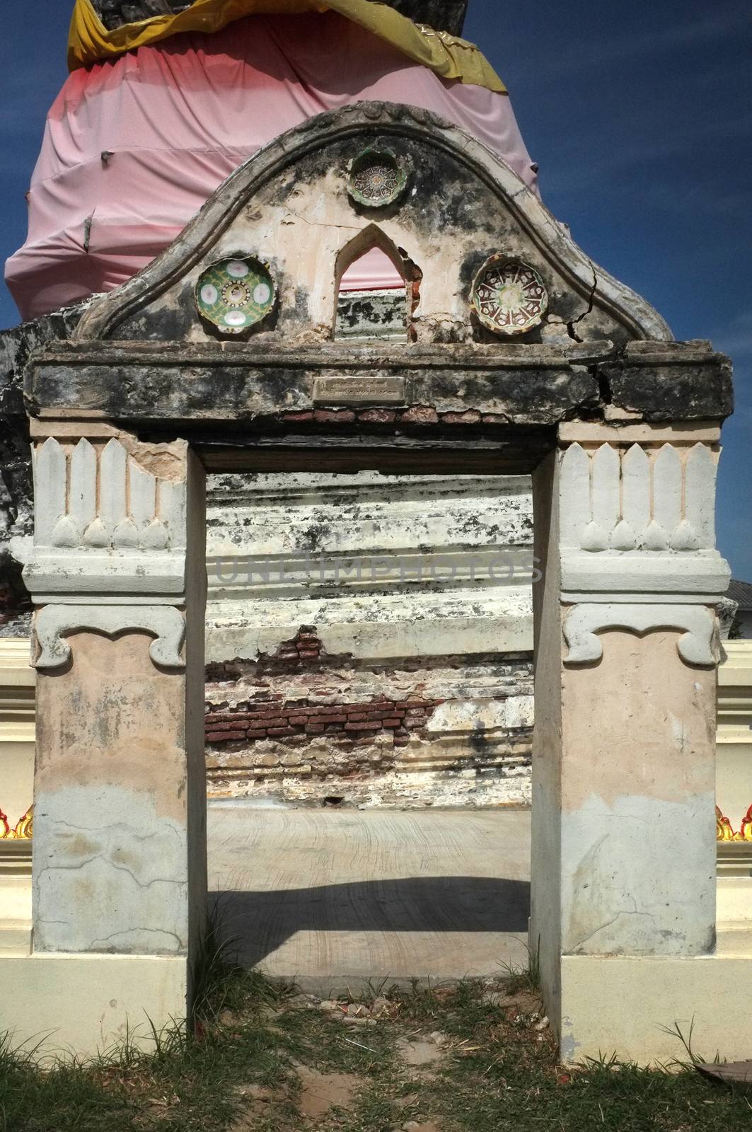 Arch way in front of Ancient stupa in temple of Thailand