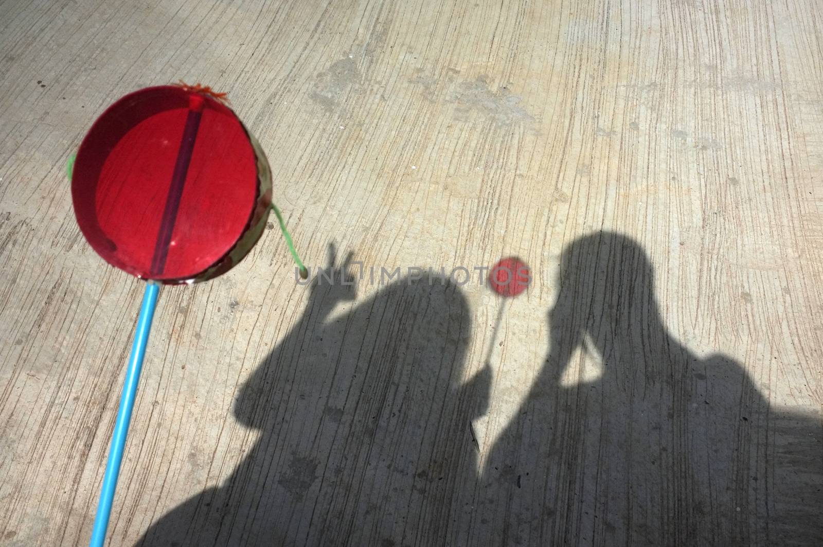 Silhouette of couple playing asian hand drum toy