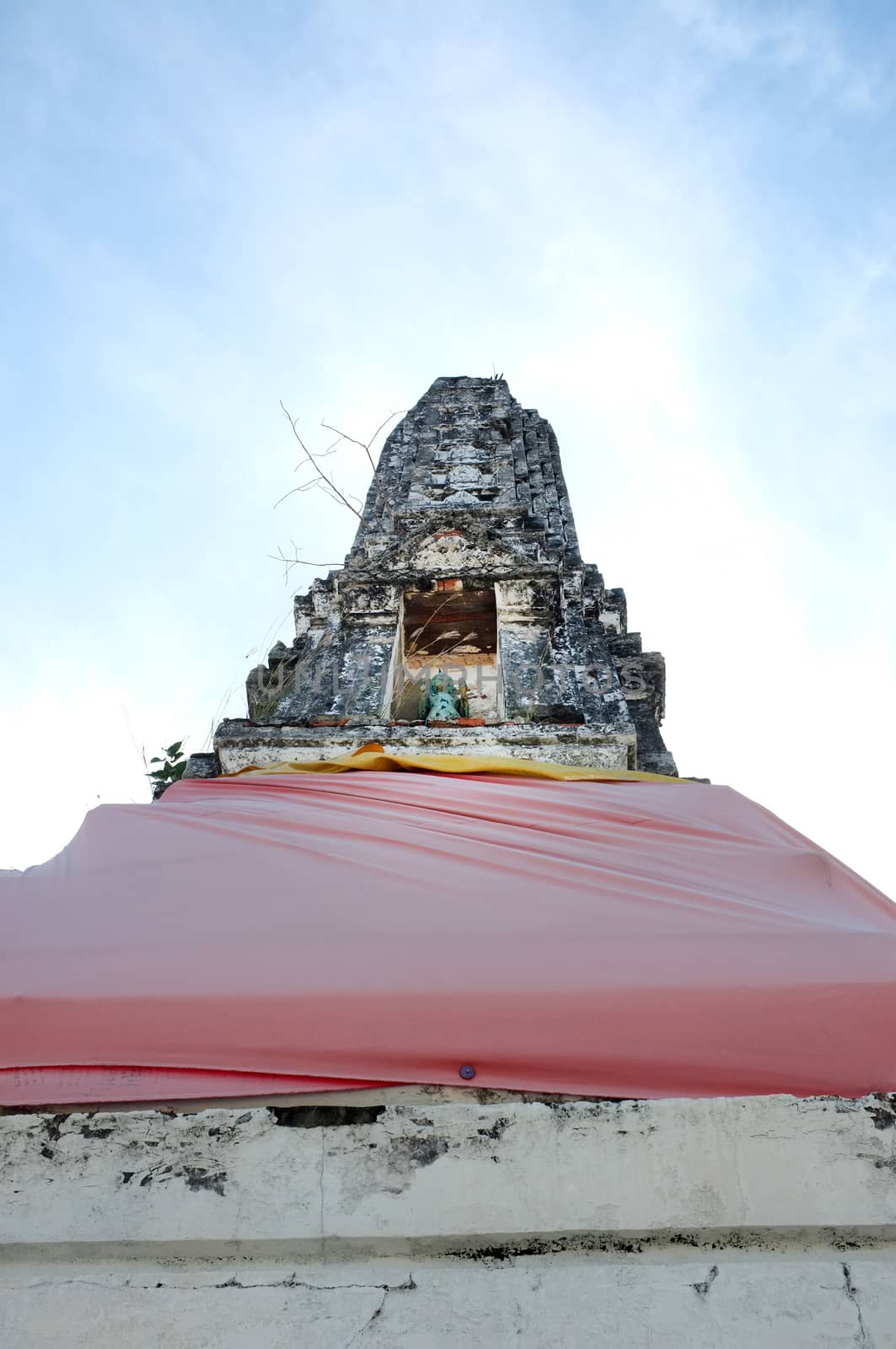 Ancient stupa in temple of Thailand with blue sky background