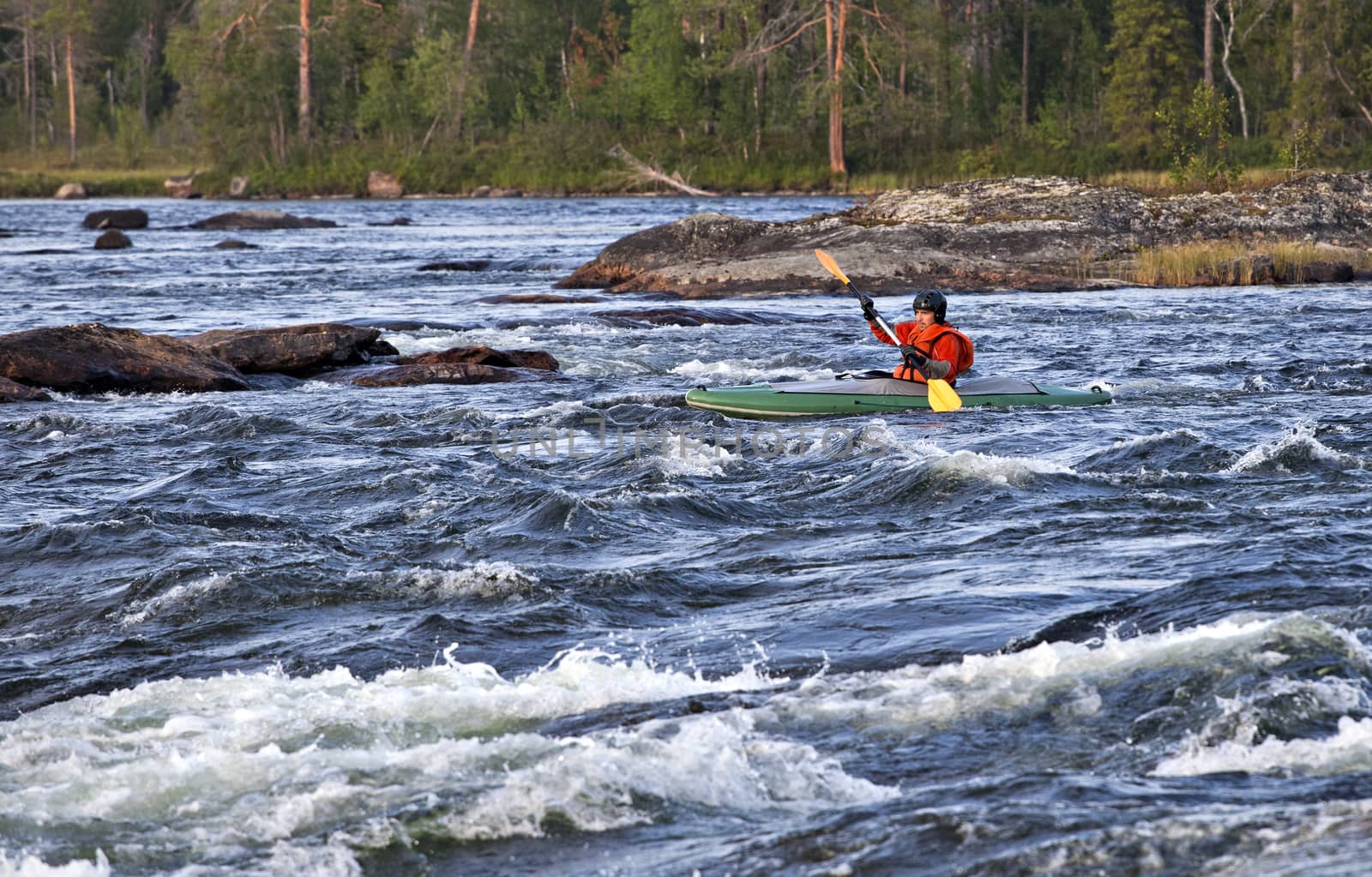 Kayaker in the  whitewater of a river Umba in Russia