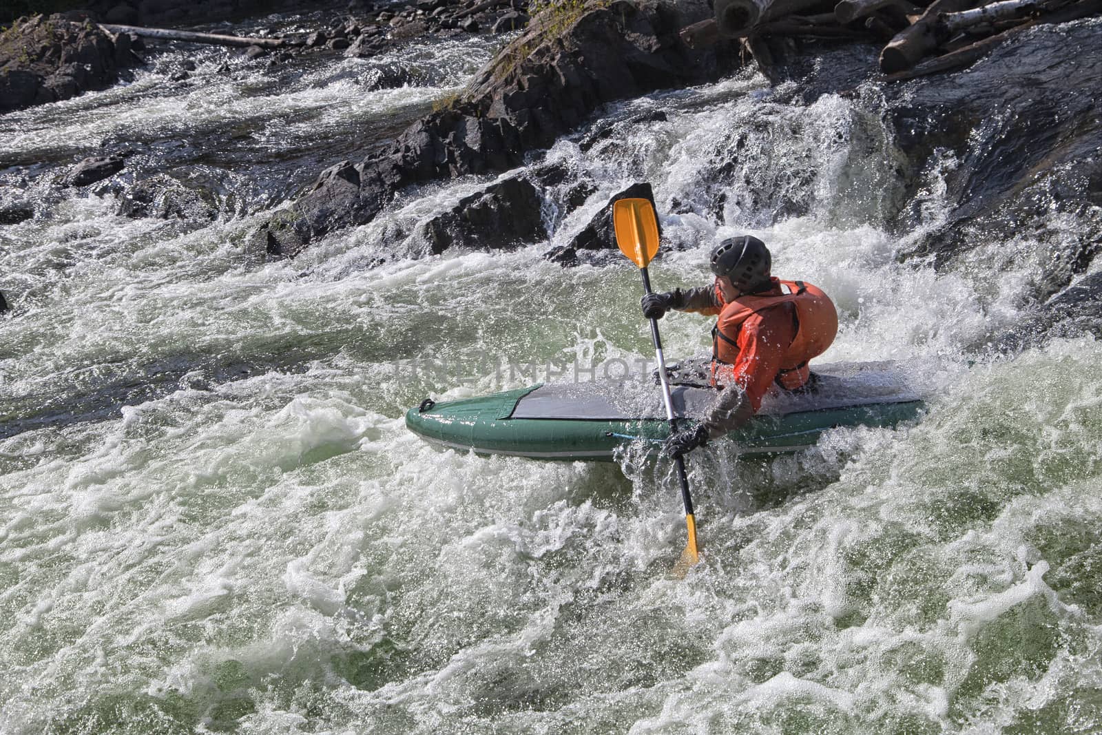 Kayaker in the  whitewater of a river Umba in Russia