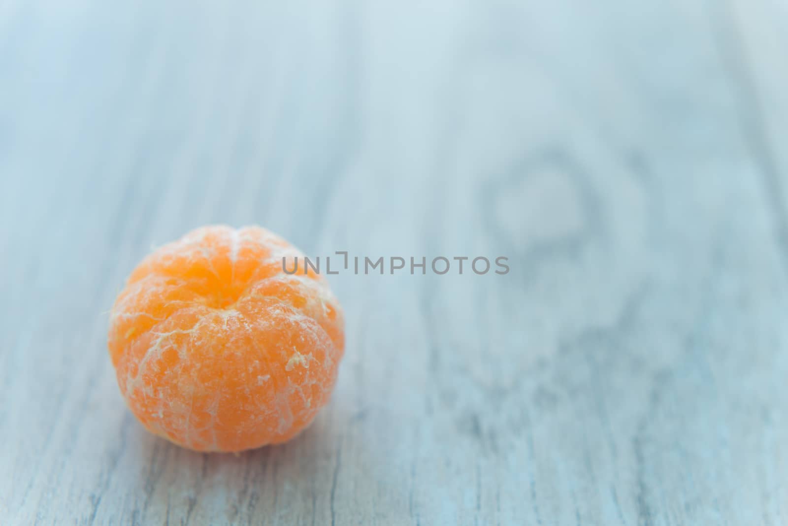 Tangerine lays on the wood background
