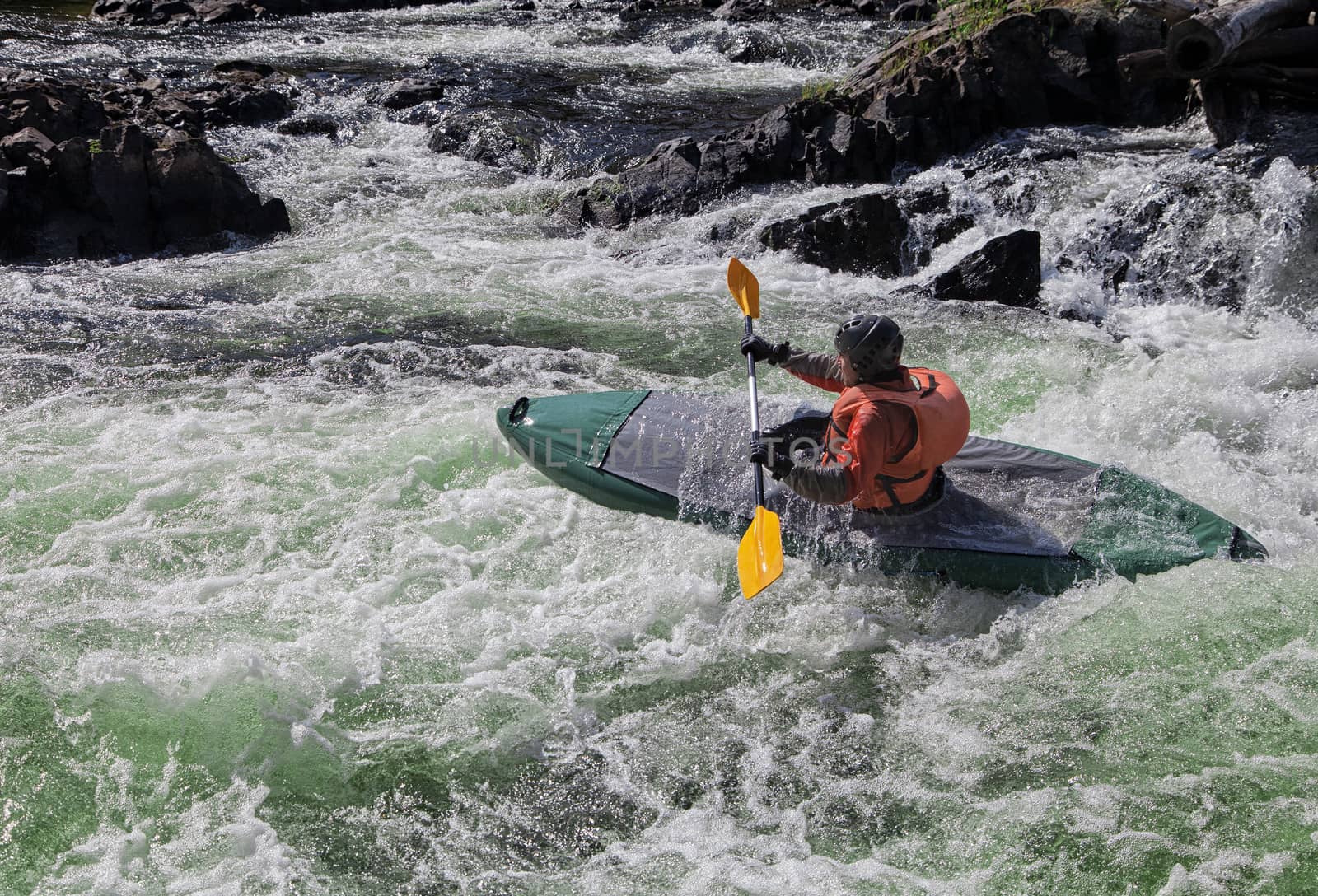 Kayaker in the  whitewater of a river Umba in Russia