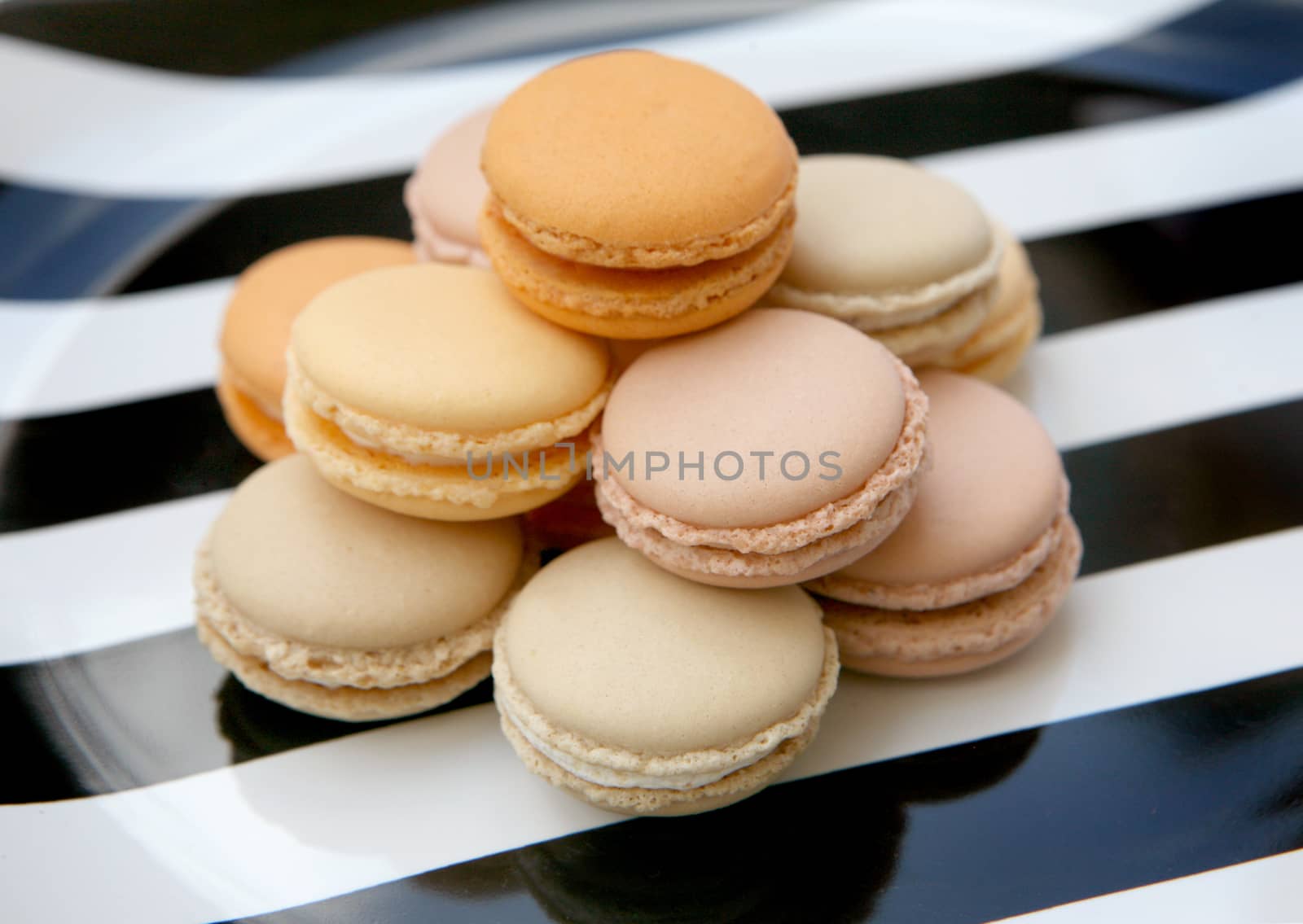 French colorful macaroons isolated on lace white by ohhlanla