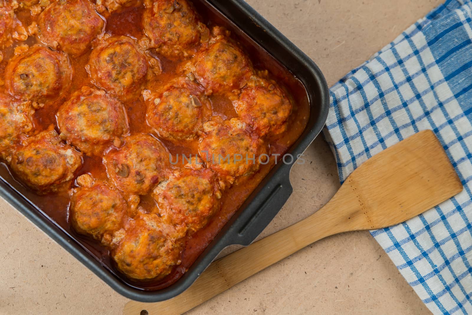 Meatballs in baking dish and wood spoonula