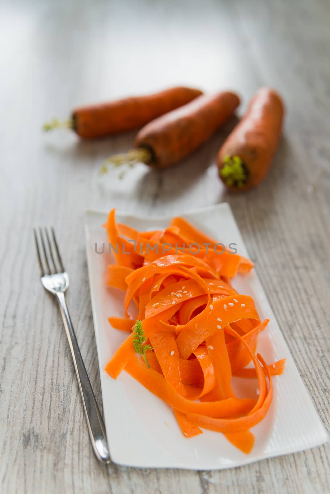 Carrot salad on the white plate by Linaga