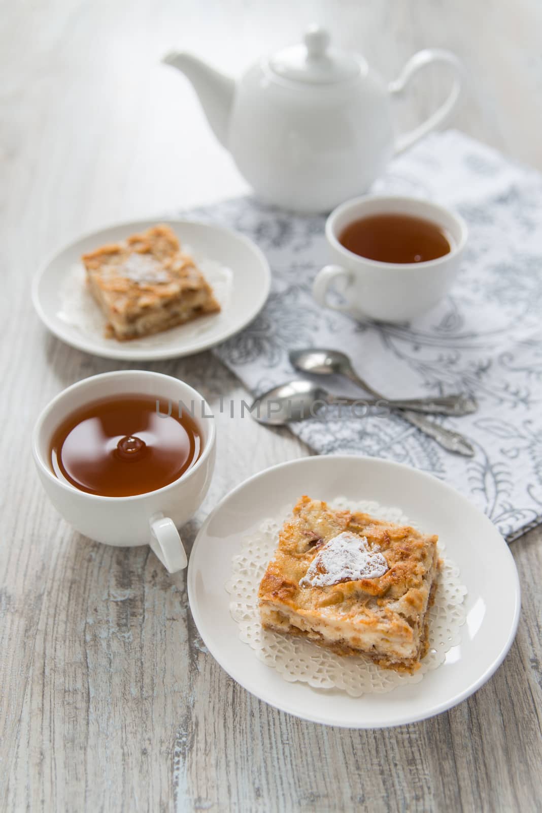 Two pieces of apple pie with tea