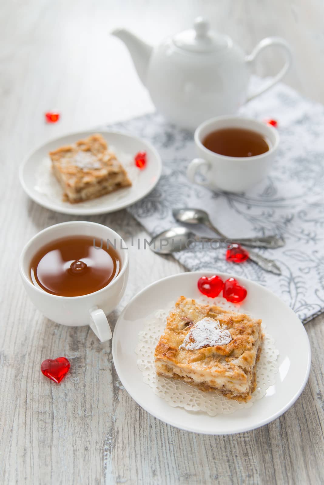 Two pieces of apple pie with tea