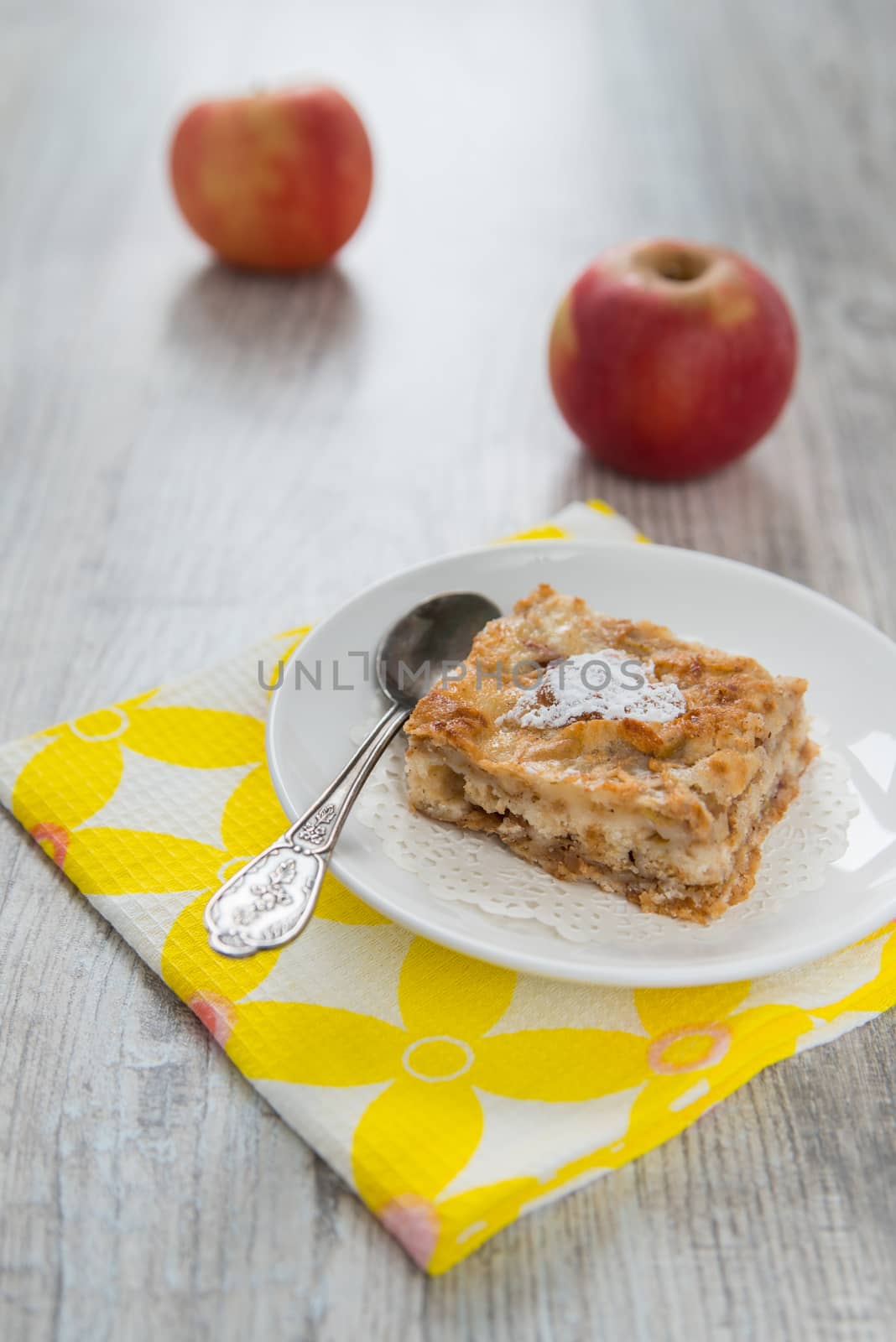 Piece of an apple pie and two apples