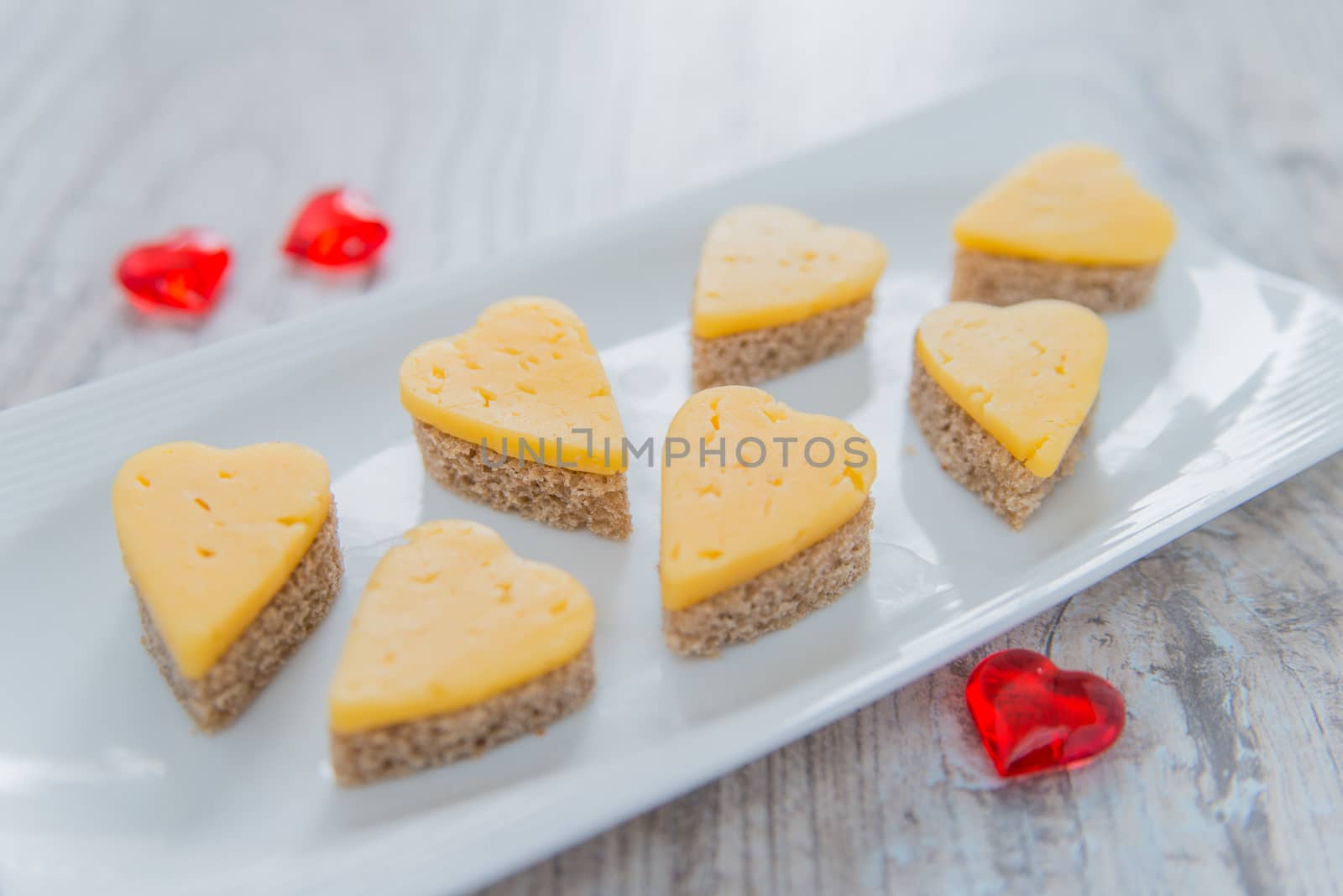 Heart shaped cheese sandwiches on the white plate