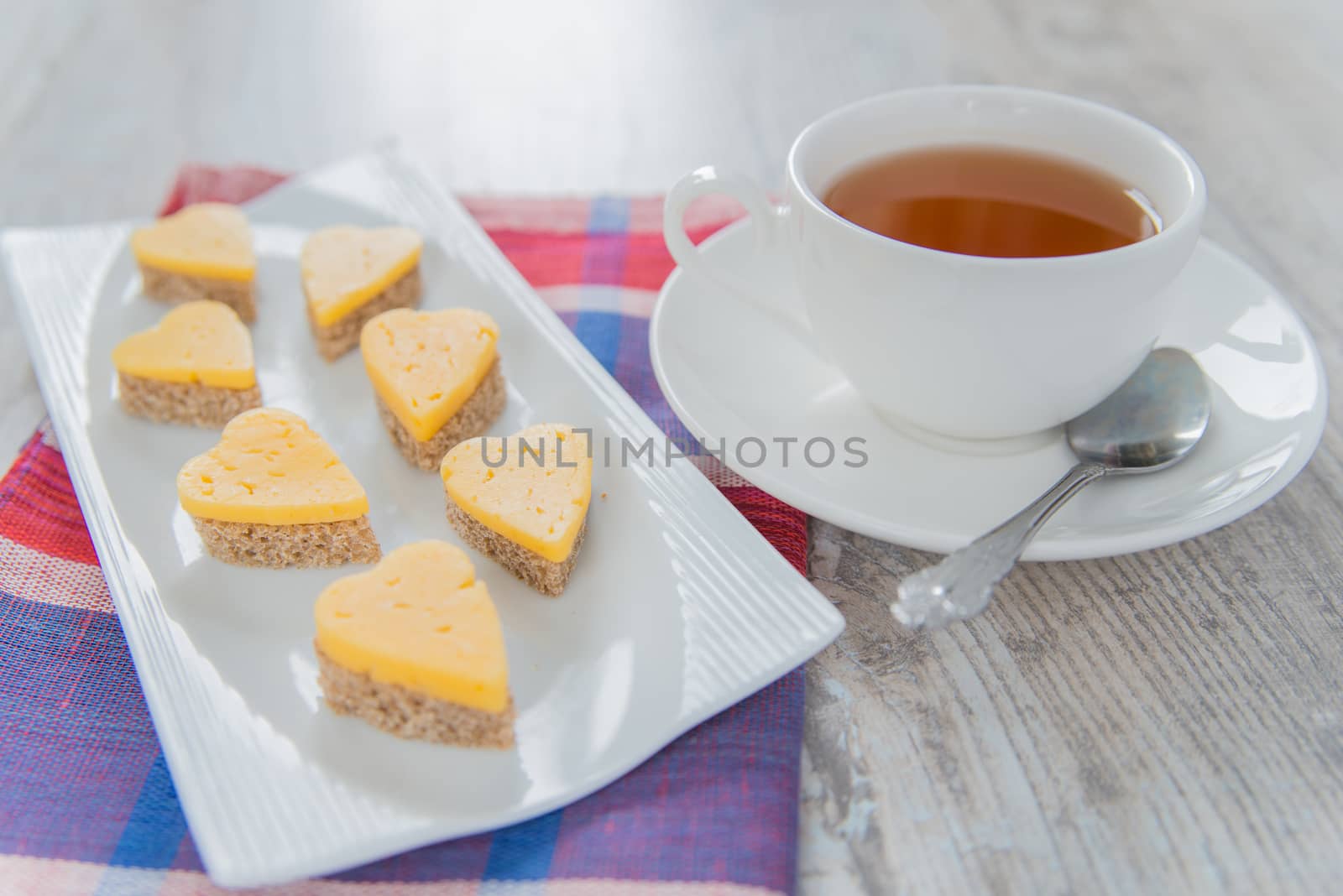 Heart shaped cheese sandwiches with tea