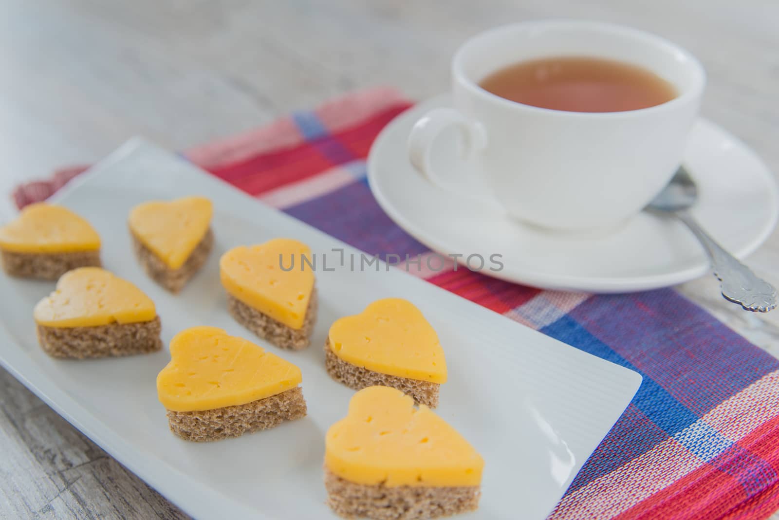 Heart shaped cheese sandwiches with tea