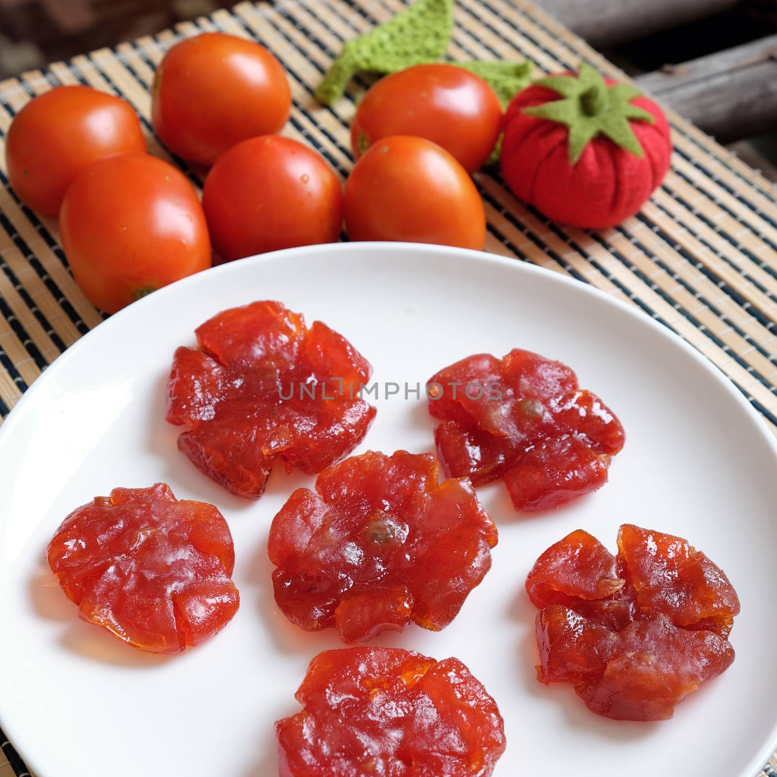 Vietnamese food for Tet holiday in spring, tomato jam, sweet eating is traditional food on lunar new year, can make from tomato cook with sugar,  amazing background for Vietnam custom