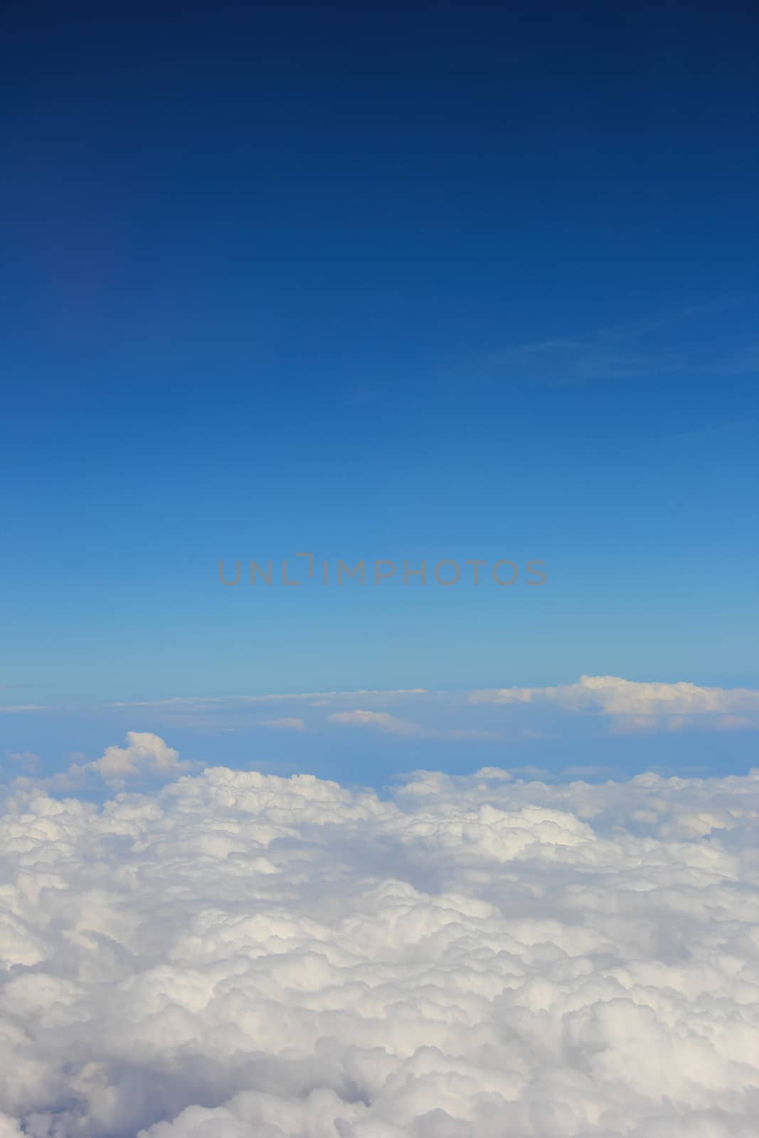 Soft clouds over view from airplane flying