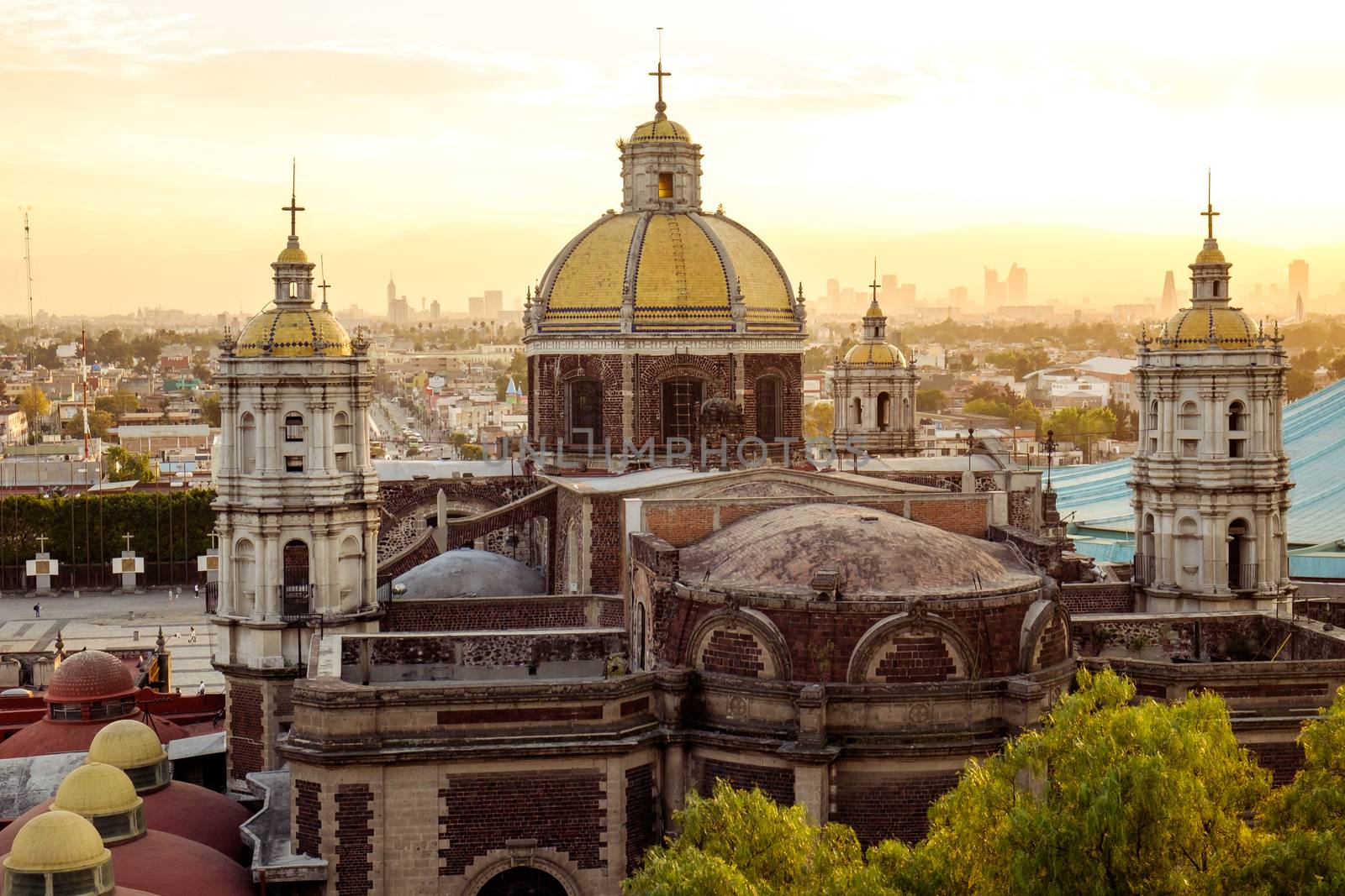 Scenic view of Basilica of Guadalupe with Mexico city skyline at sunset, Mexico