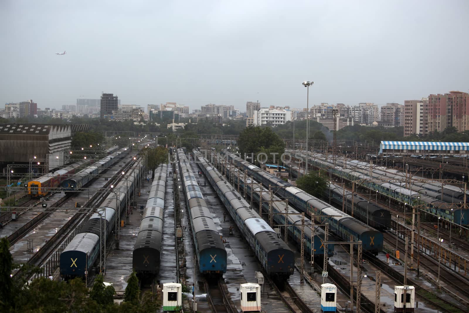 A birds eye view of trains at a railway junction in Mumbai, India on a rainy evening.