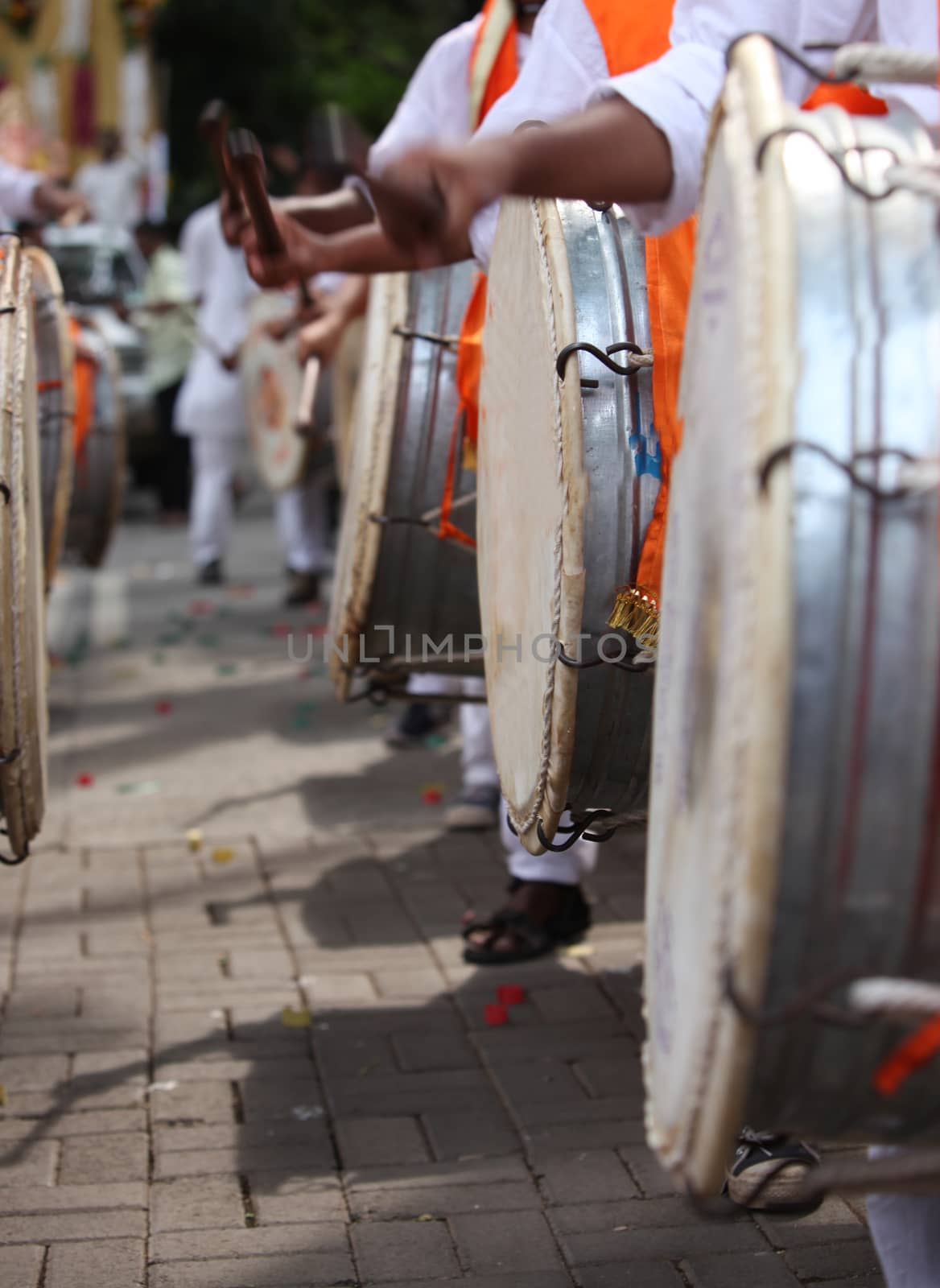 An abstract view of drummers hitting the traditional drum called the DHOL during a traditional Ganesh festival procession