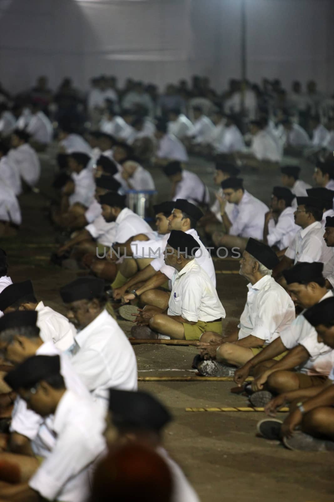 Young and old members of the old right winged Hindu organisation RSS gather for a meeting at night in India. Rashtriya Swayamsevak Sangh abbreviated as RSS . "National Volunteer Organisation" or National Patriotic Organisation) is a right-wing volunteer, Hindu nationalist, non-governmental organisation. It is the world's largest voluntary non-governmental organisation. RSS states that its ideology is based on the principle of selfless service to India.