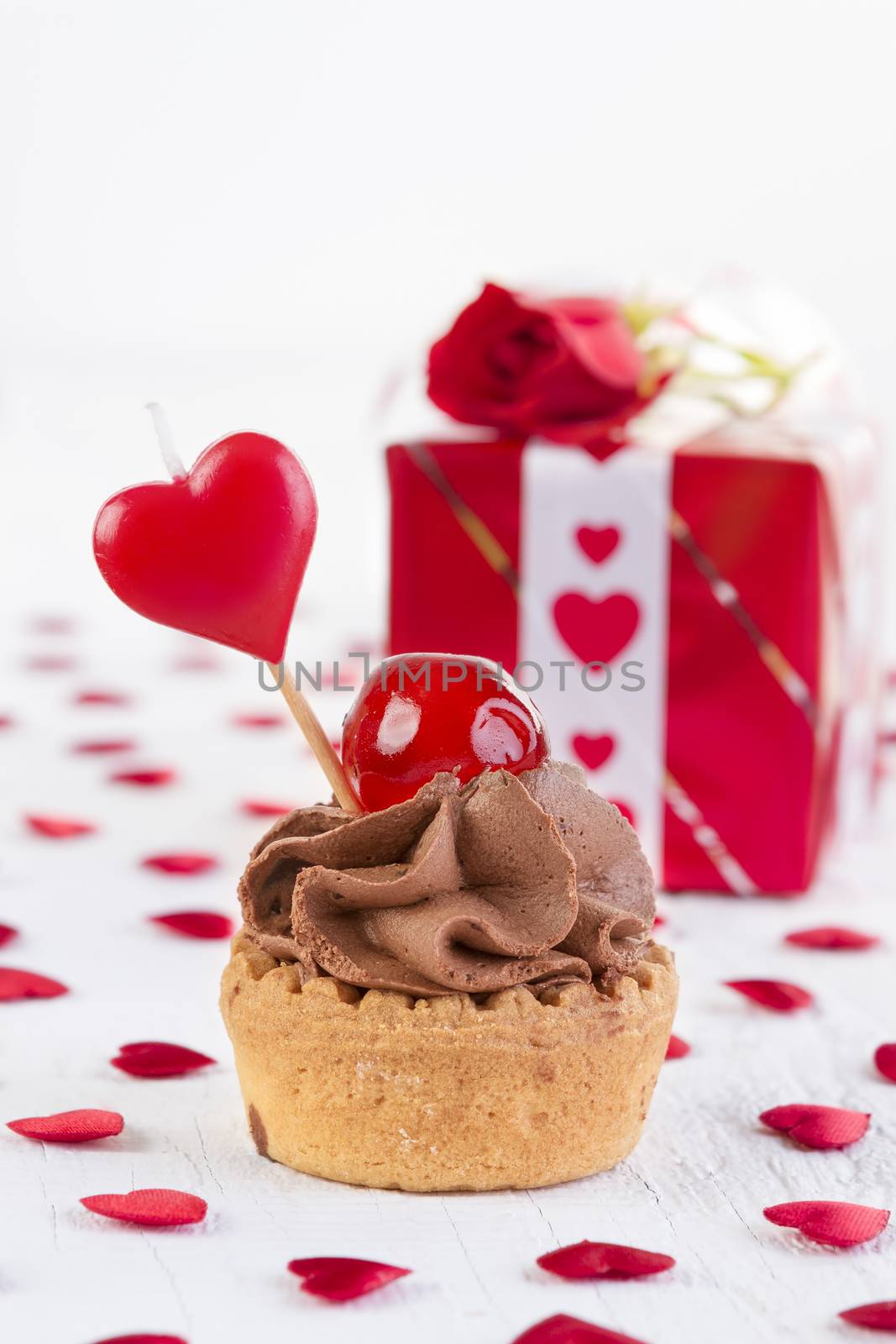 cup-cake with cherry in front of gift box  by manaemedia