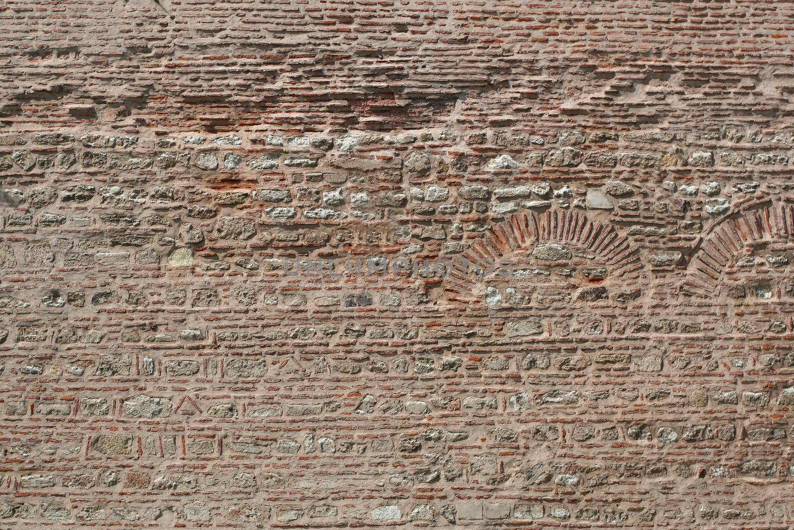 Old brick wall with the pattern for the archs