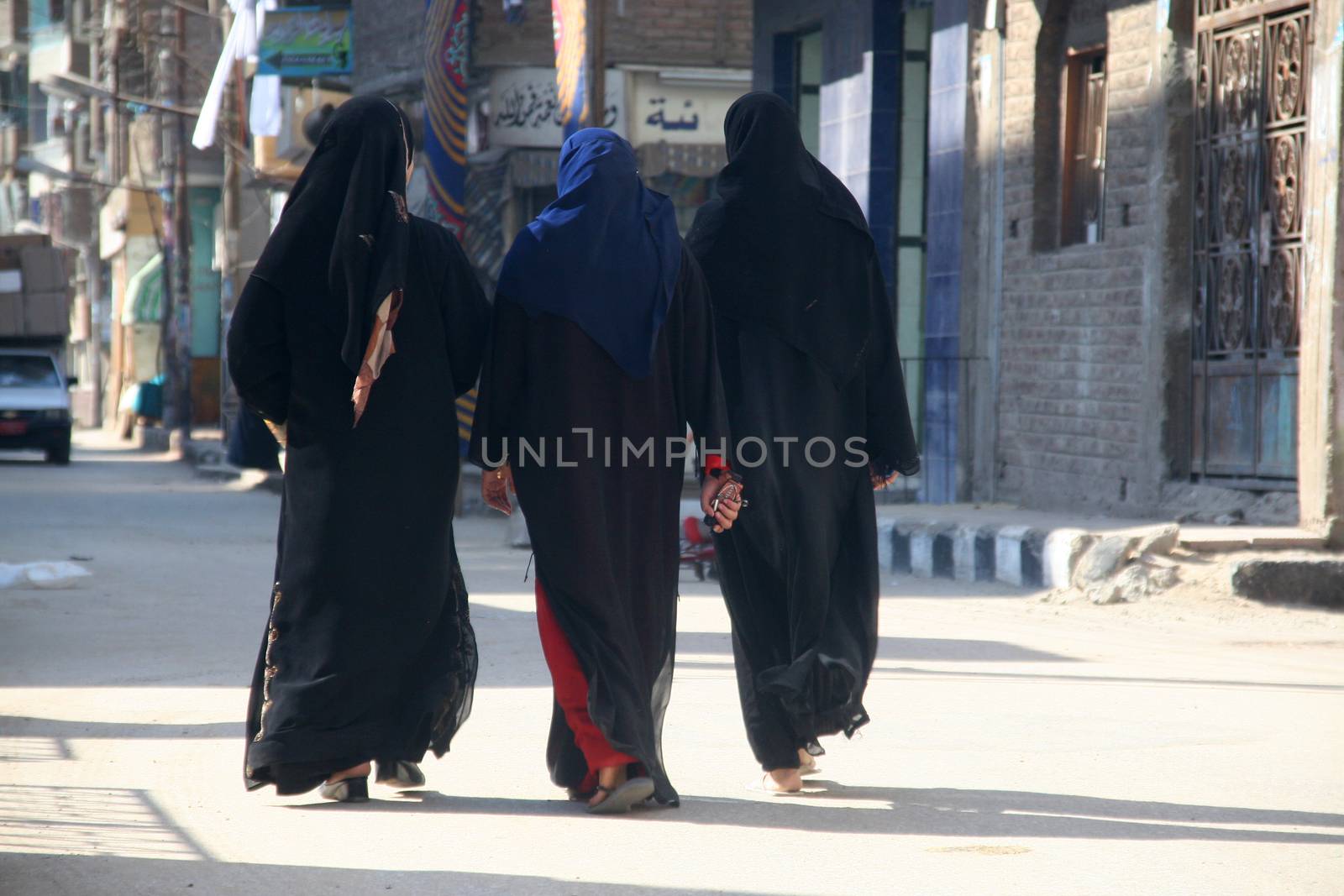 Three muslim woman walking on the street