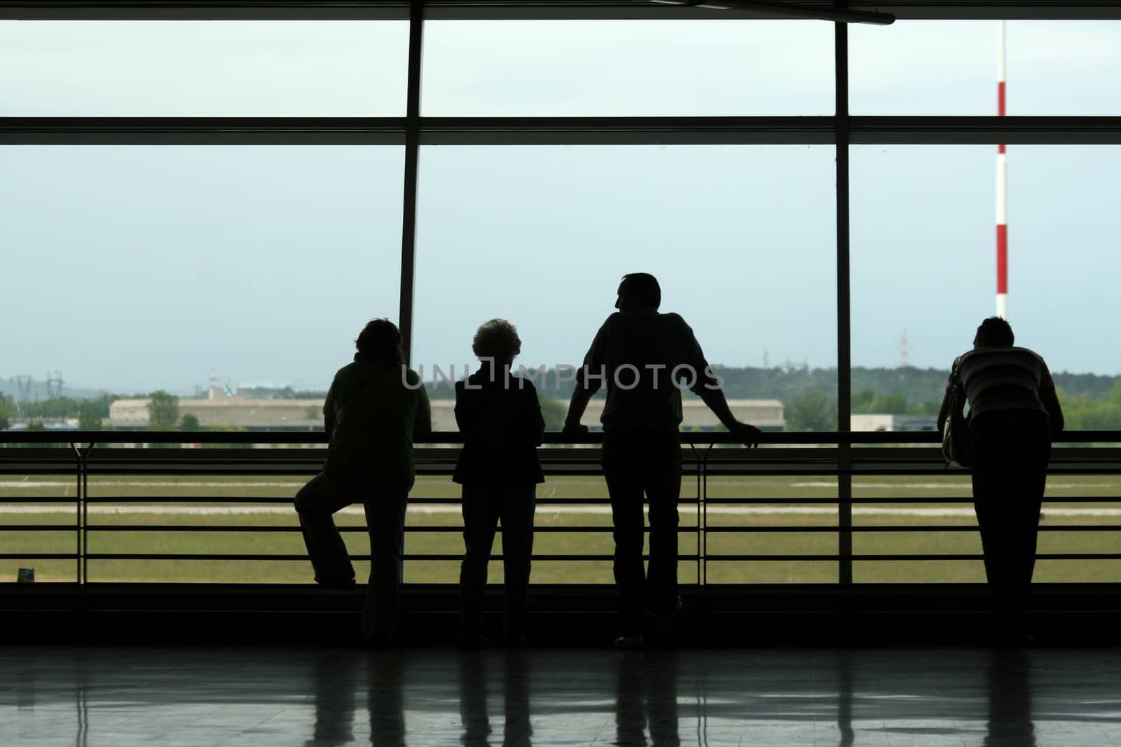 Silhouetts of people waiting at the airport