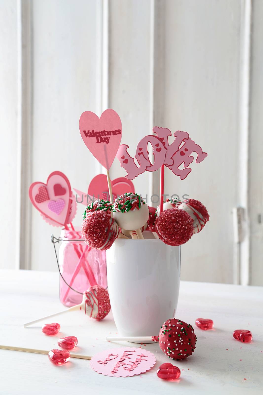 Cake pops with decorations on kitchen table by Sandralise