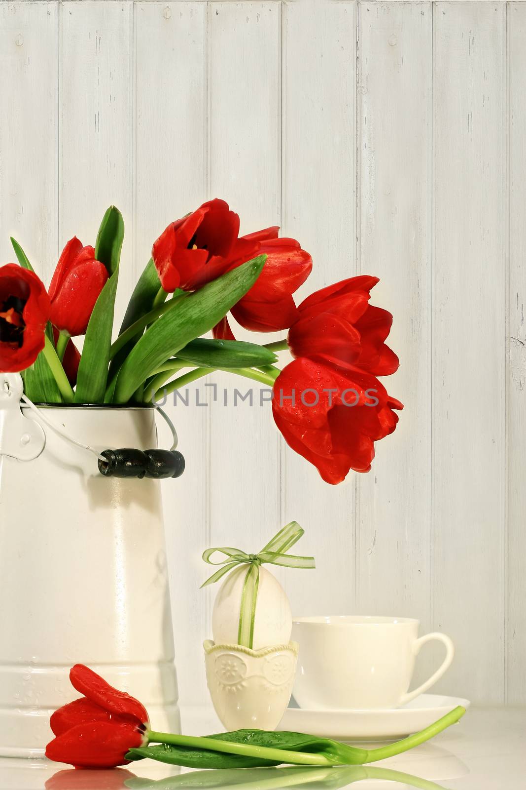 Tulips and egg with bow on table by Sandralise